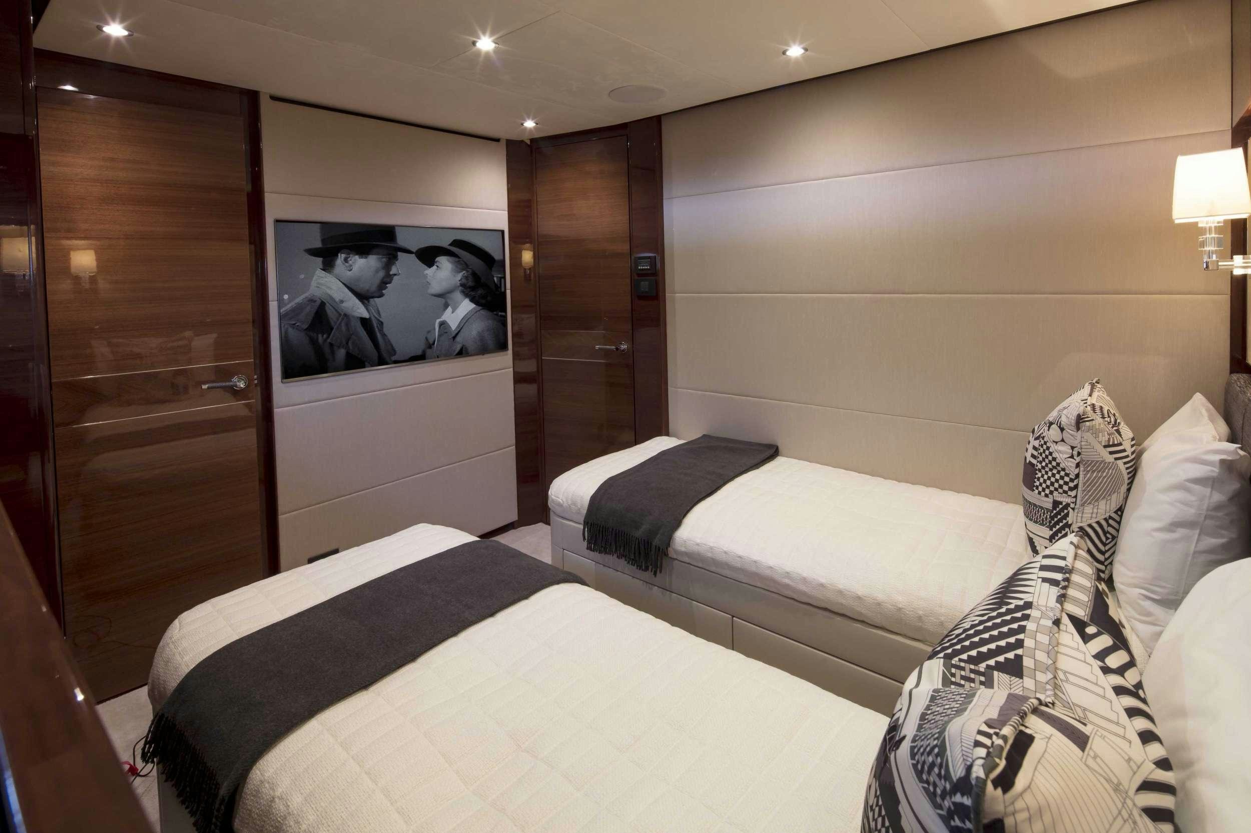 a room with a bed and a wood door aboard HOT PURSUIT Yacht for Charter