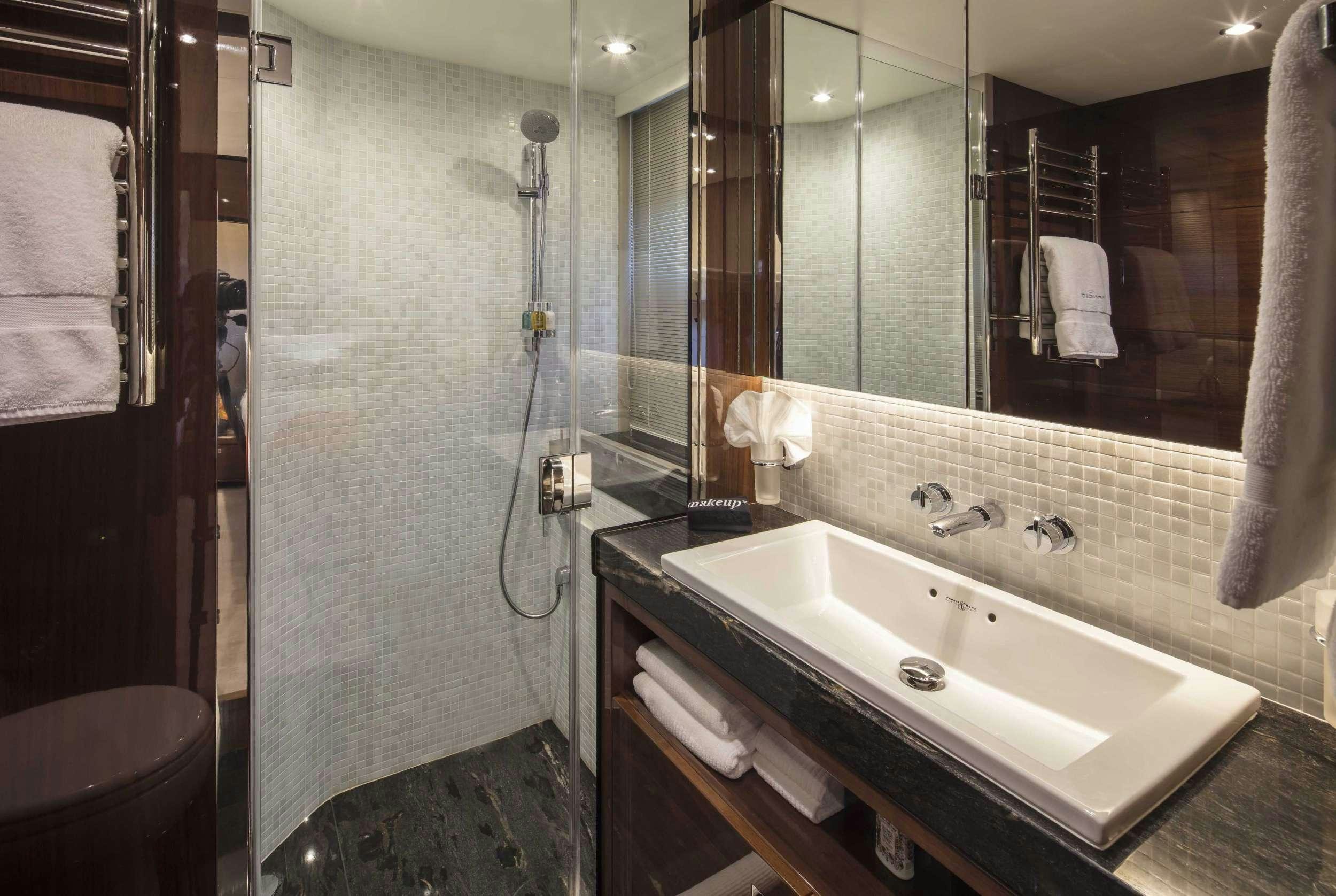 a bathroom with a sink and a mirror aboard HOT PURSUIT Yacht for Charter