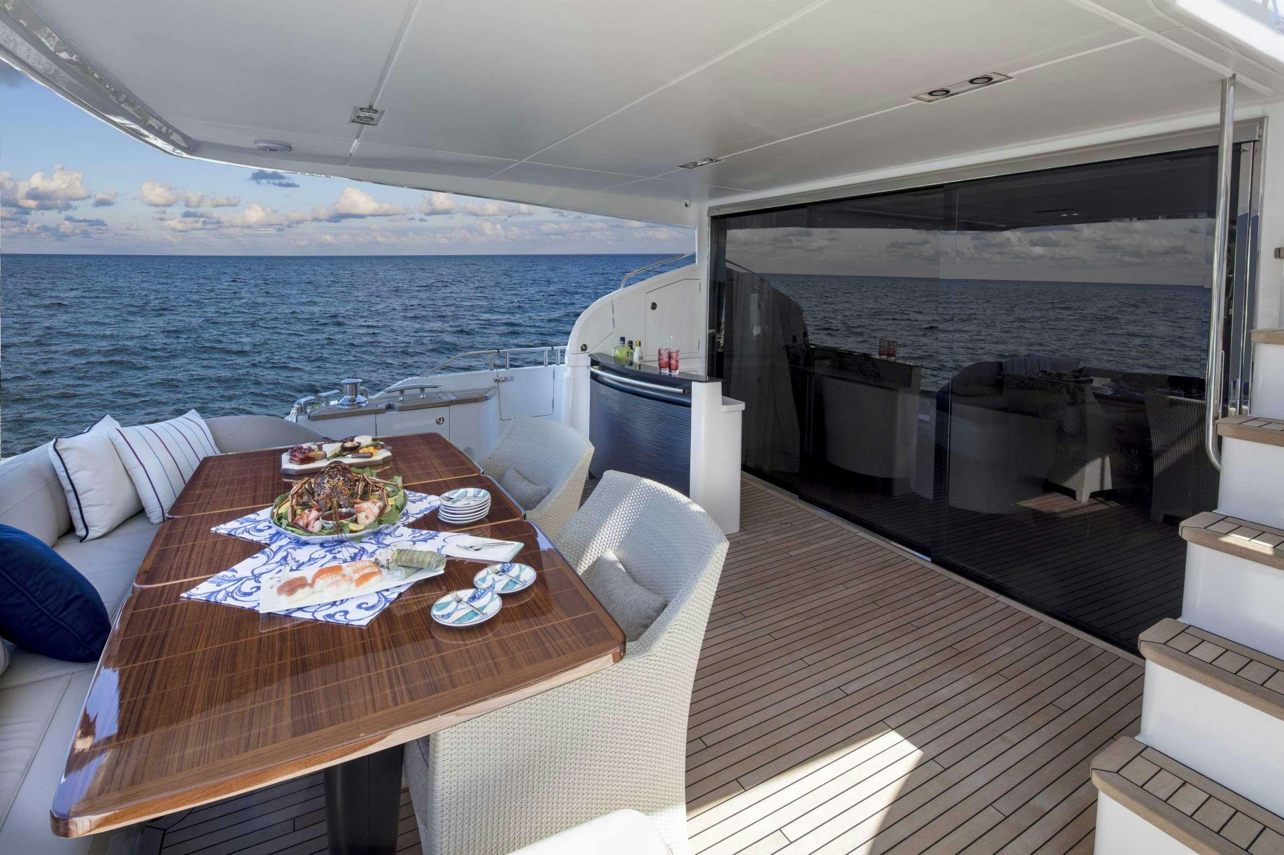 a boat with a table and chairs aboard HOT PURSUIT Yacht for Charter