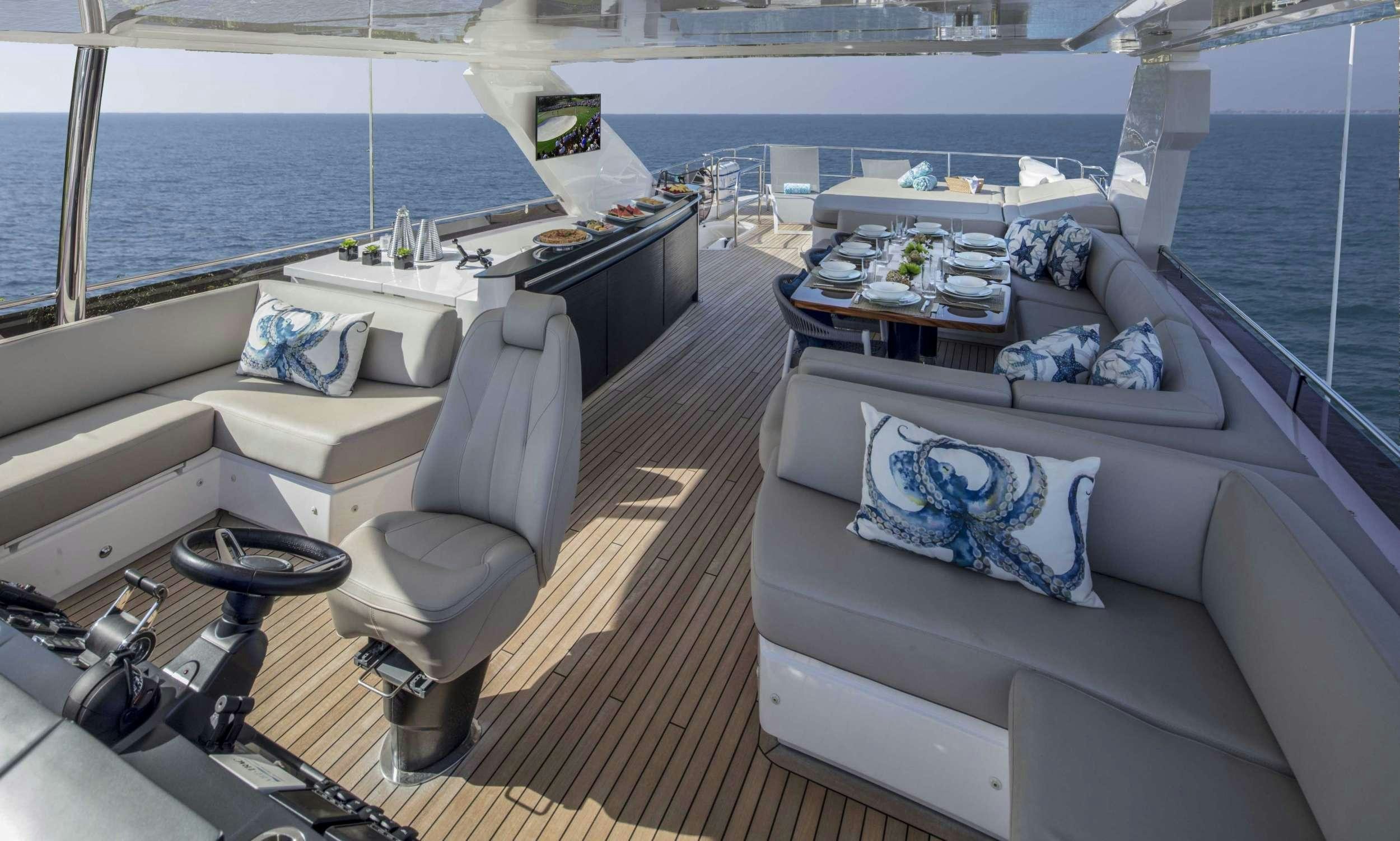 a room with a couch and a table on a boat aboard HOT PURSUIT Yacht for Charter