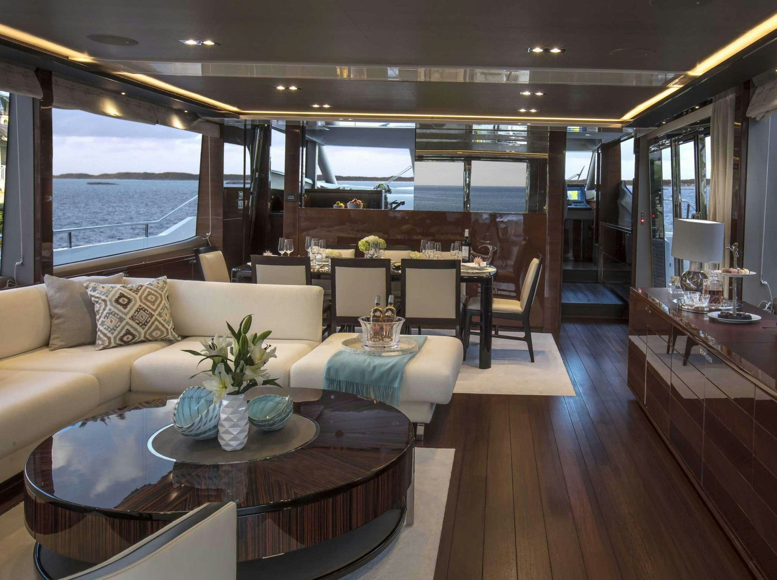 a living room with a large window aboard HOT PURSUIT Yacht for Charter