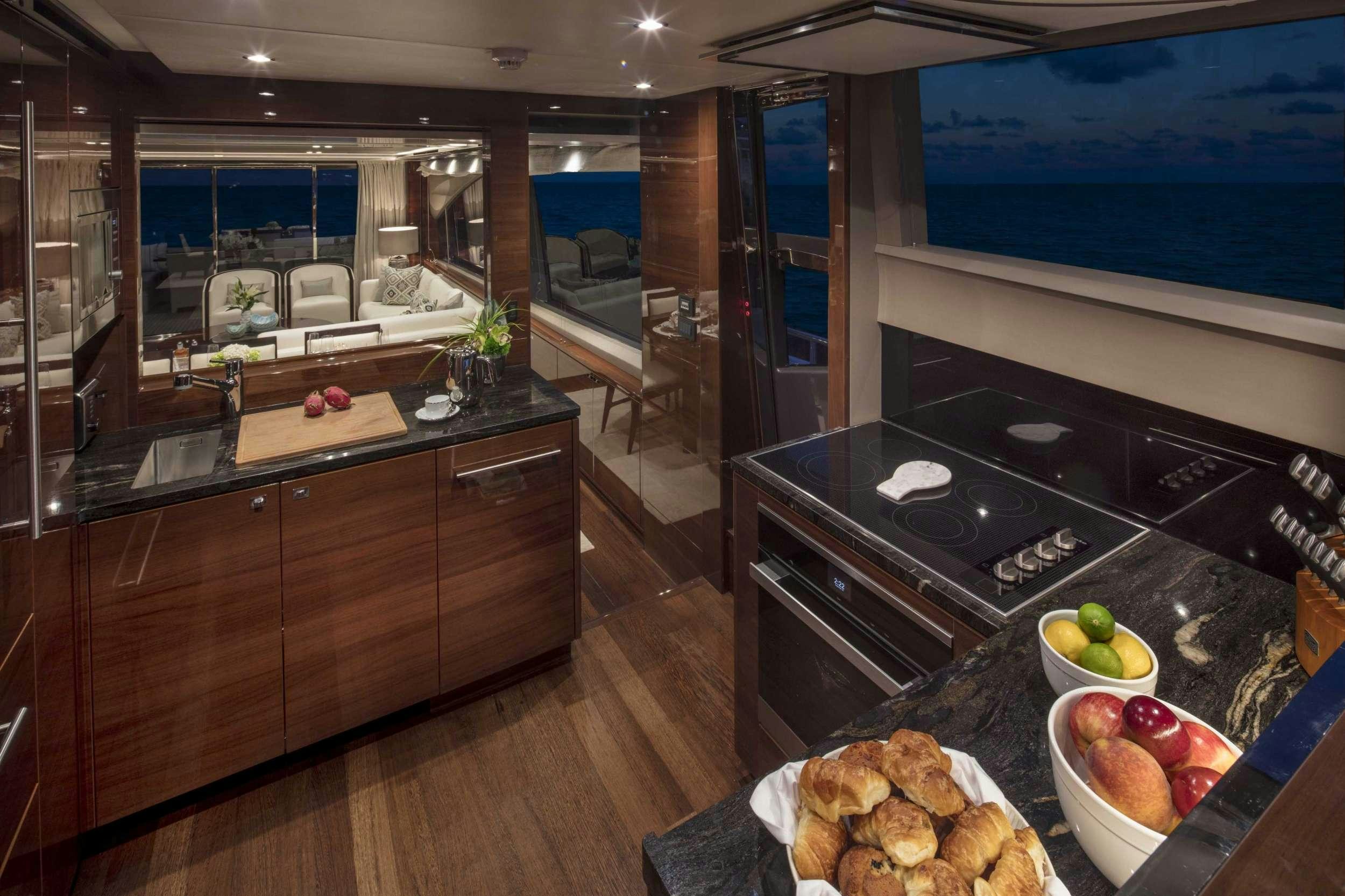 a kitchen with a countertop and a window aboard HOT PURSUIT Yacht for Charter