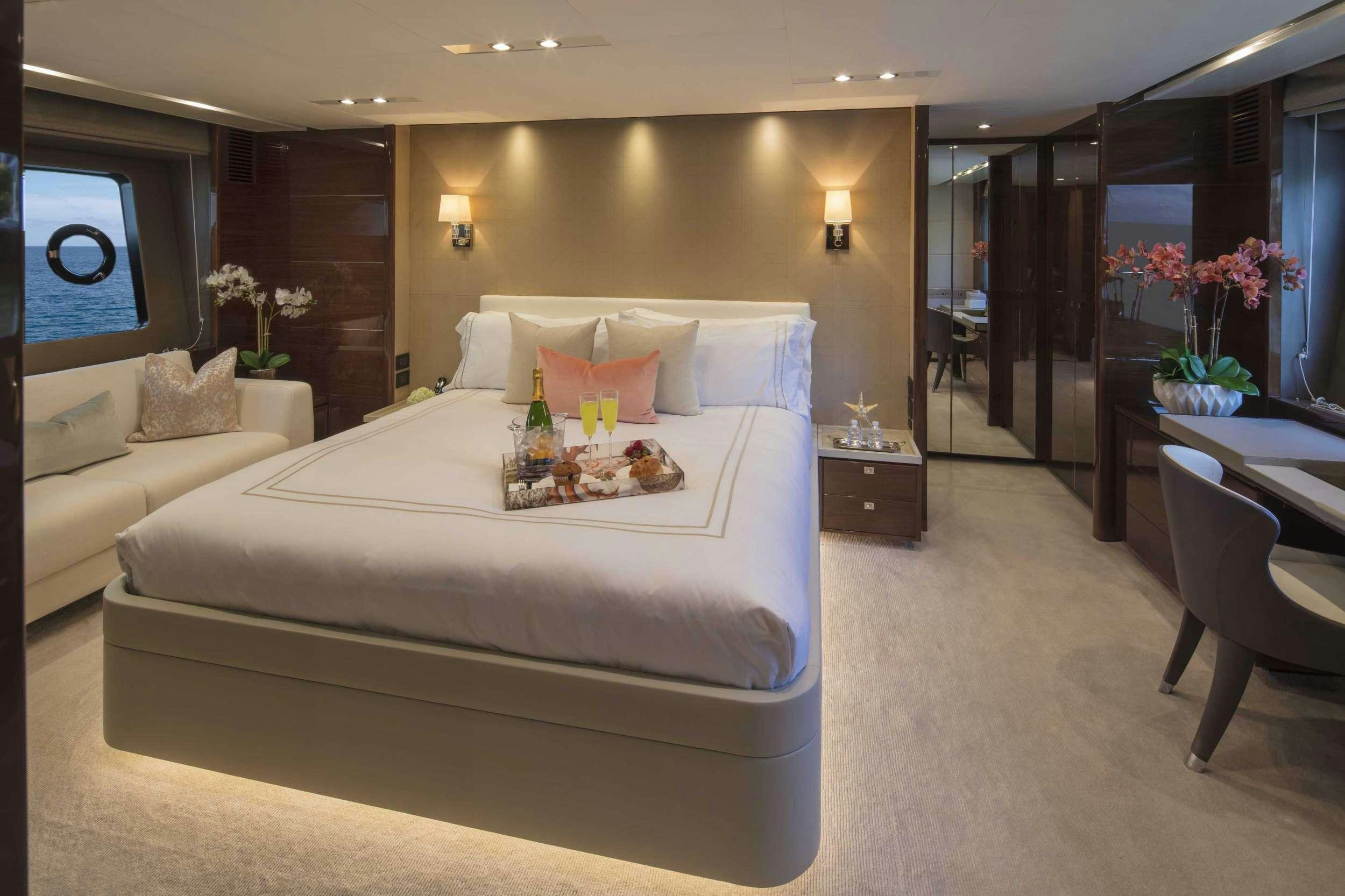 a large bedroom with a bed aboard HOT PURSUIT Yacht for Charter