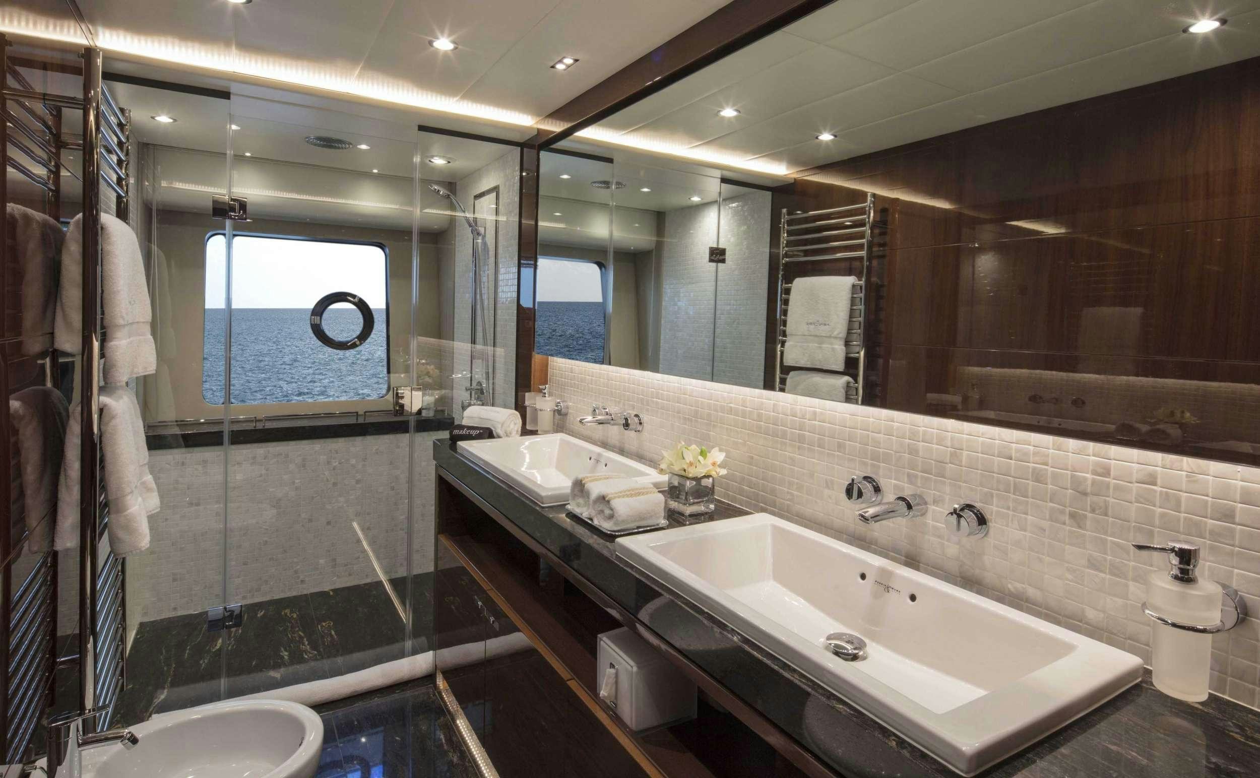 a bathroom with a large mirror aboard HOT PURSUIT Yacht for Charter