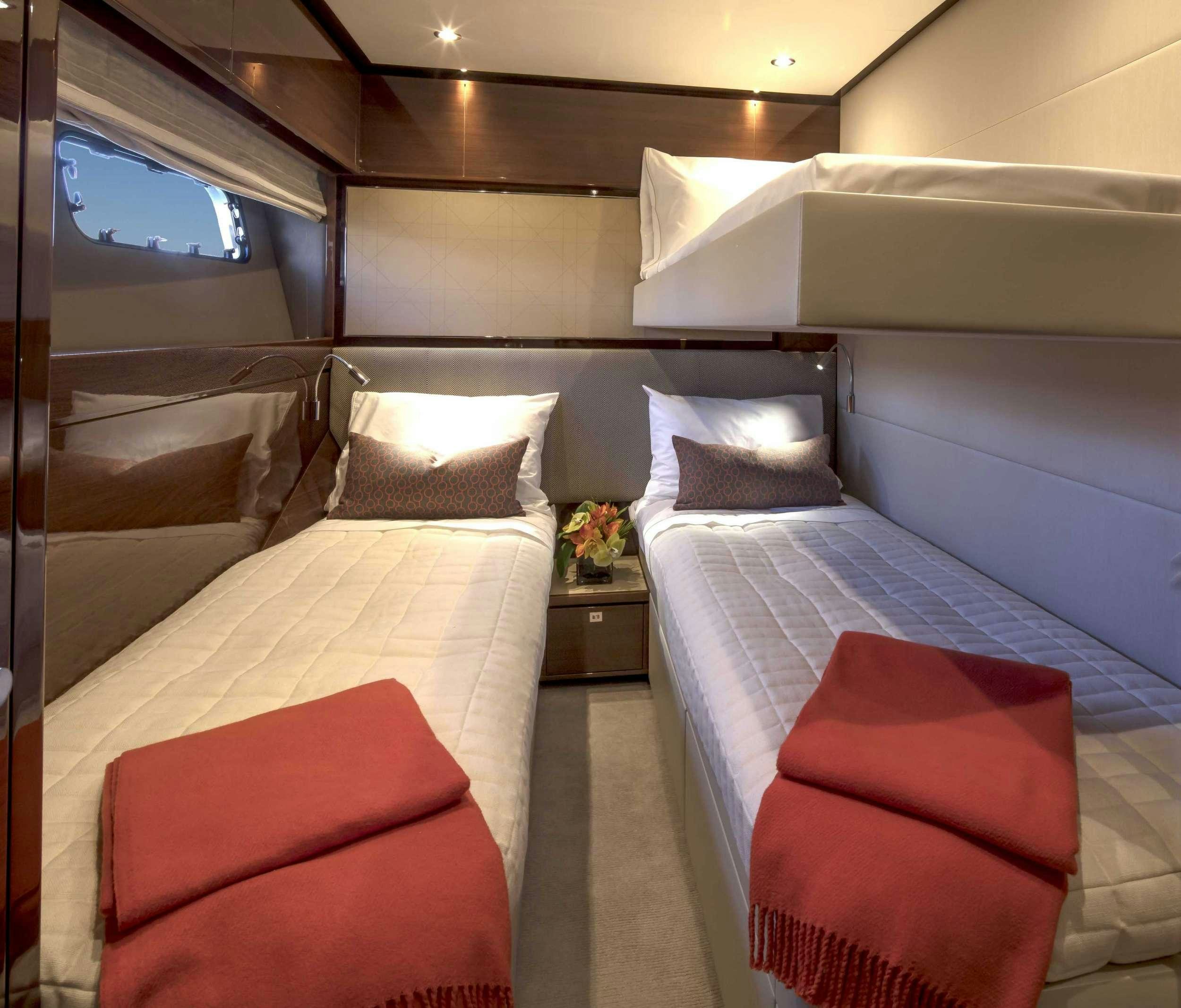 a room with two beds aboard HOT PURSUIT Yacht for Charter