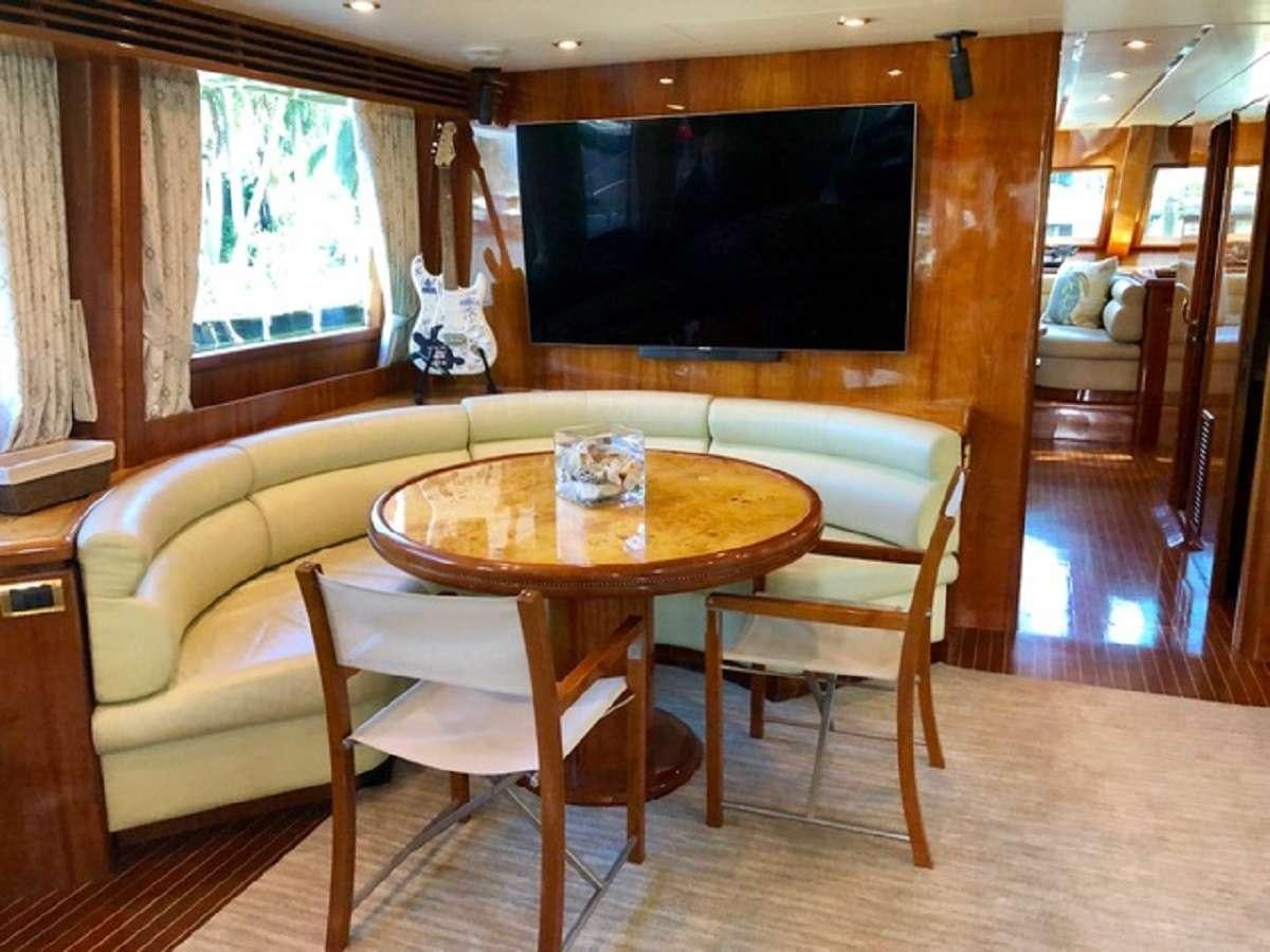 a table and chairs in a room aboard TORTUGA Yacht for Charter