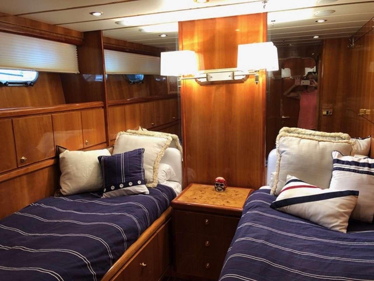 a room with a bed and a desk aboard TORTUGA Yacht for Charter