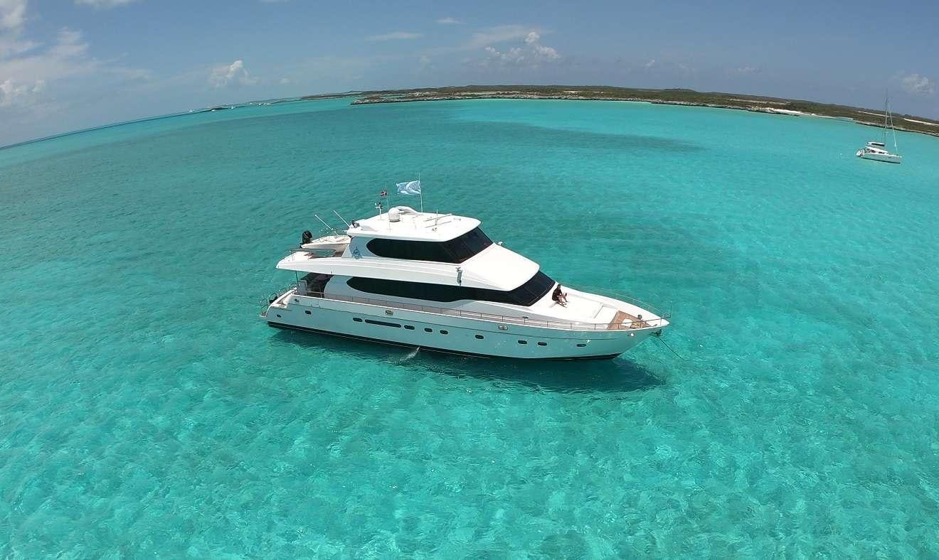 a white boat in the water aboard TORTUGA Yacht for Charter