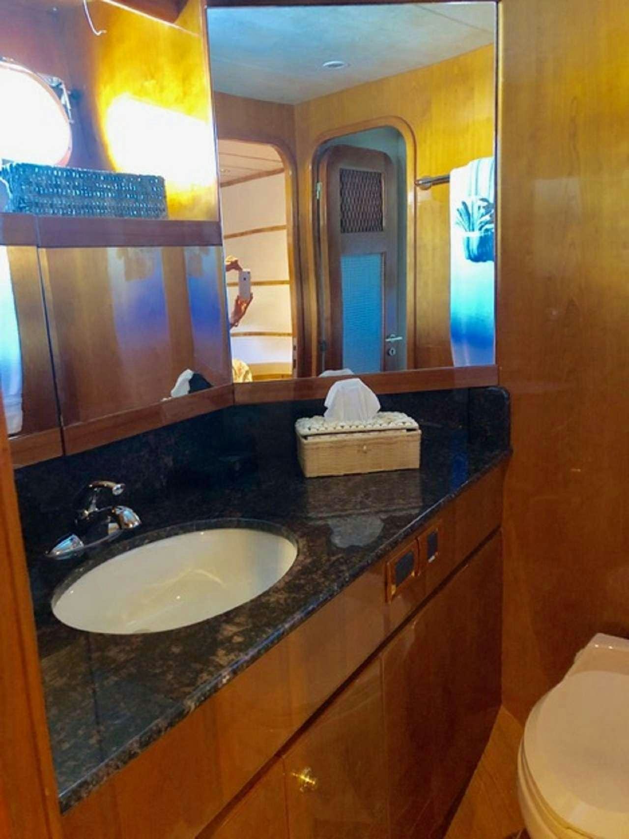a bathroom with a sink and mirror aboard TORTUGA Yacht for Charter