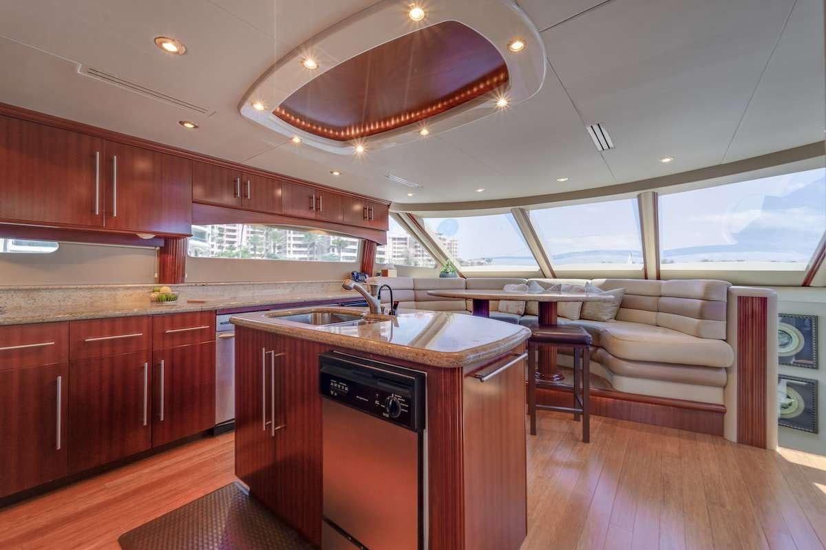 a kitchen with wooden cabinets aboard COPAY Yacht for Charter