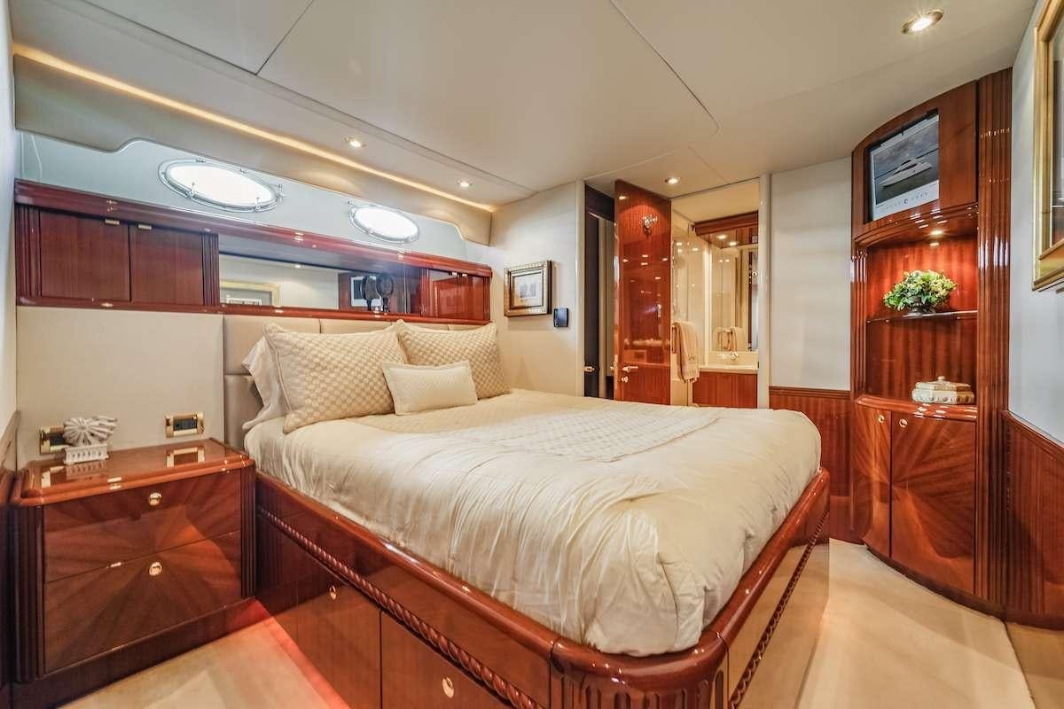 a bedroom with a bed and a dresser aboard COPAY Yacht for Charter
