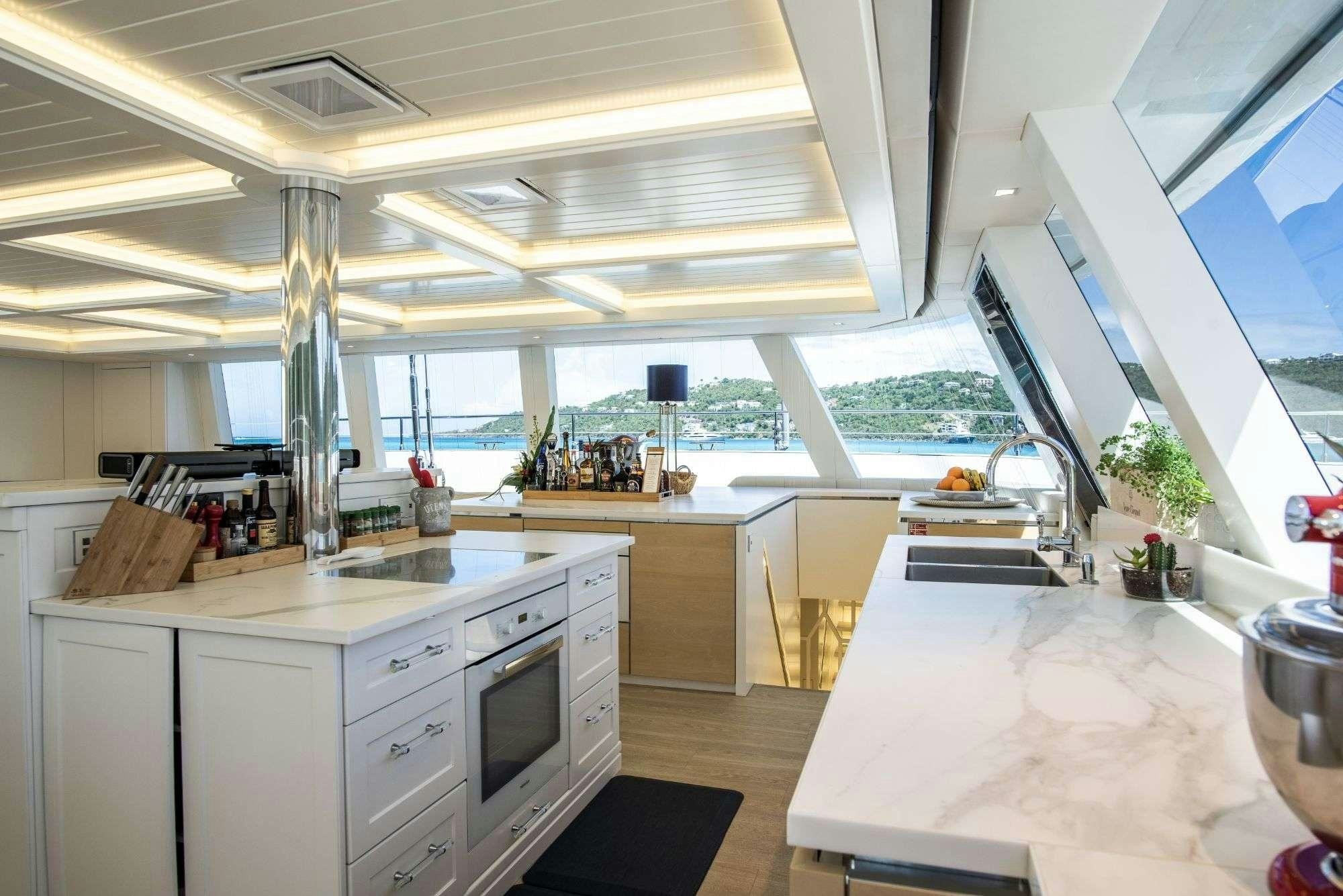 a kitchen with white cabinets aboard BUNDALONG Yacht for Charter