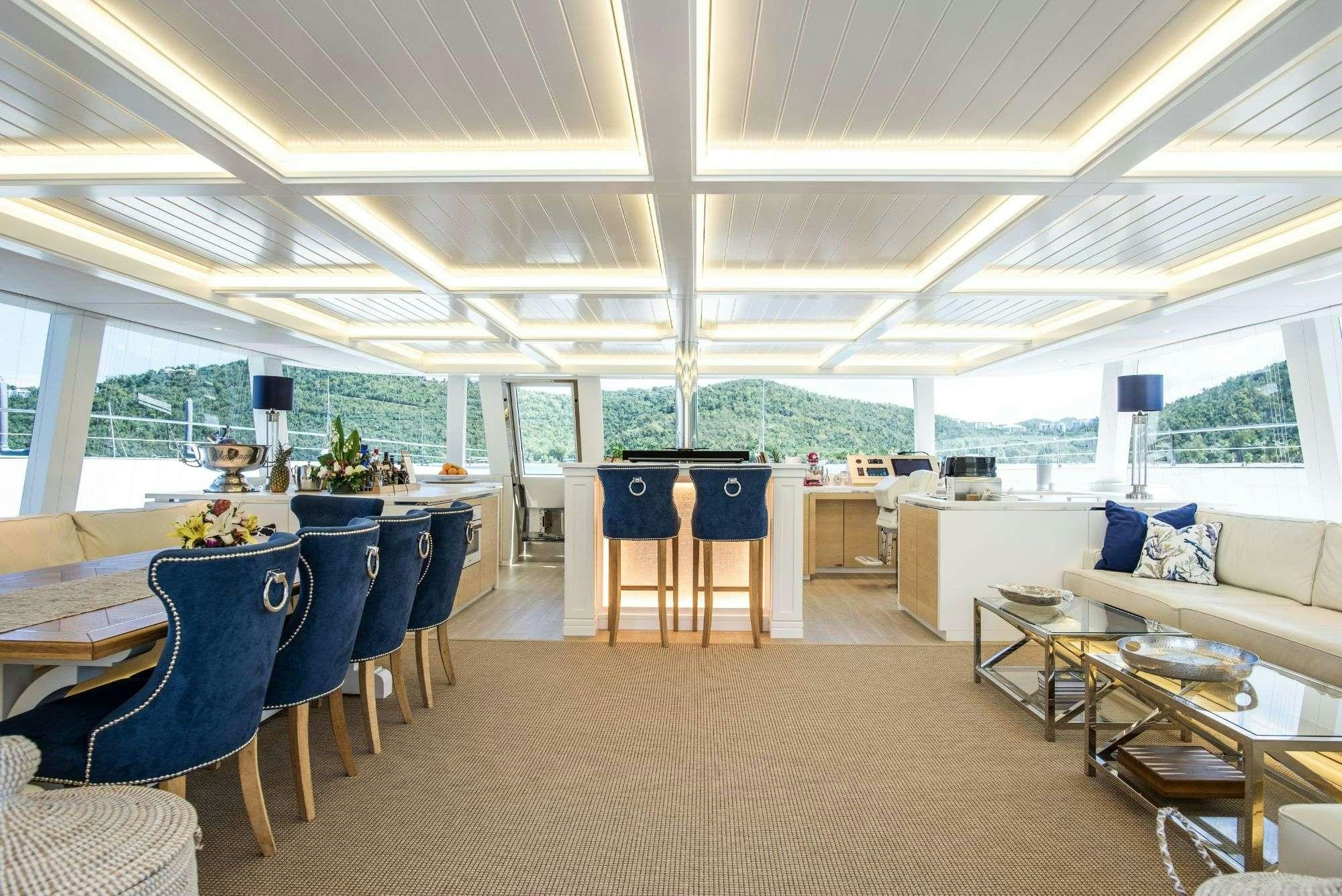 a large room with tables and chairs aboard BUNDALONG Yacht for Charter