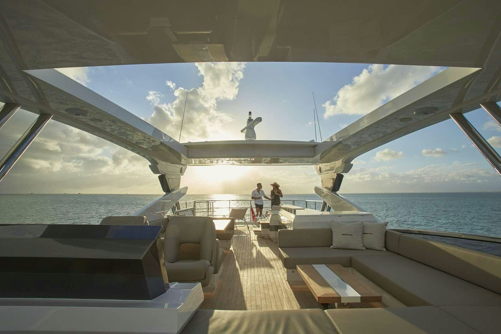 a group of people walking on a dock over water aboard pearl Yacht for Charter