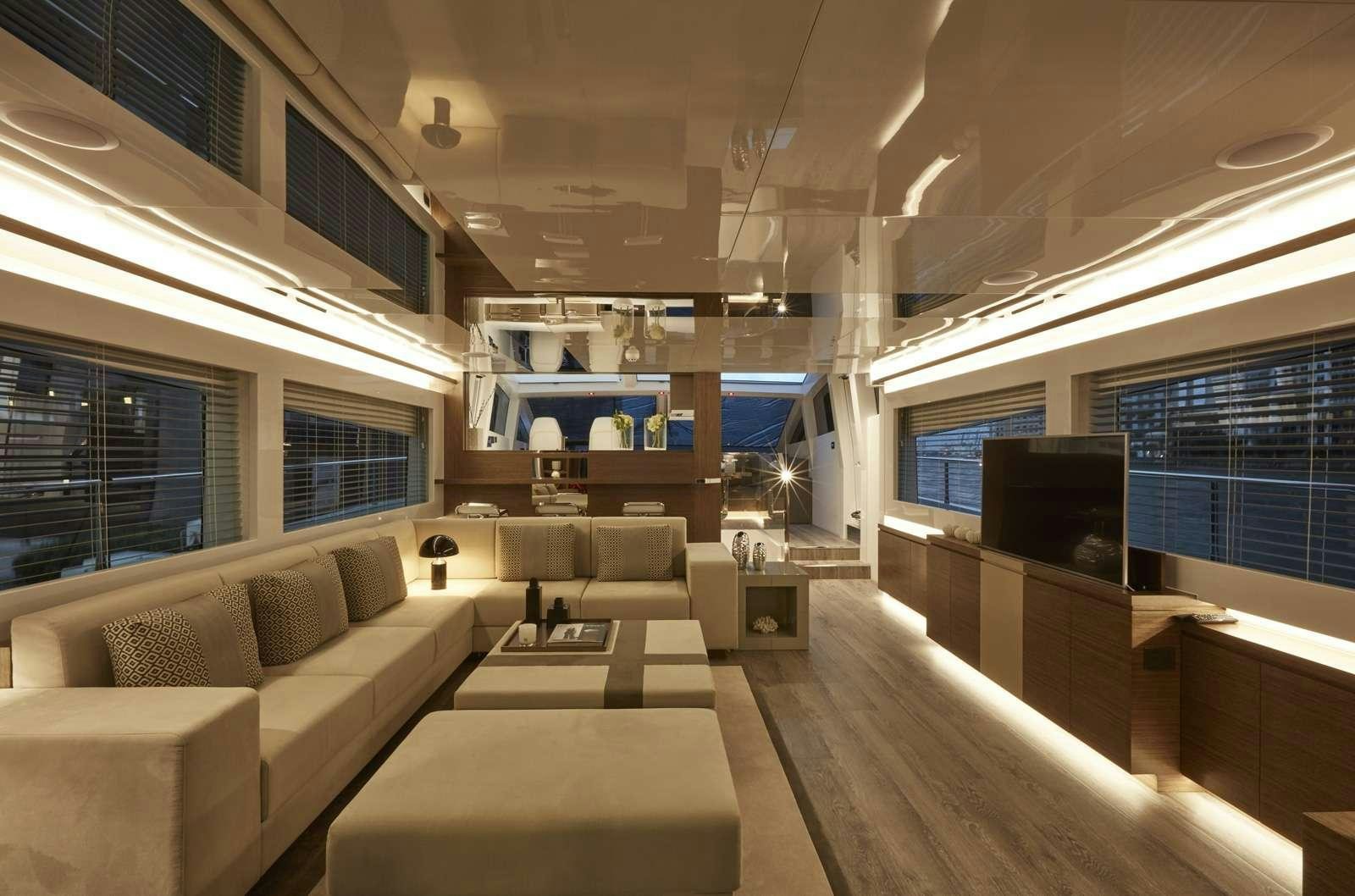 a room with a couch and a tv aboard pearl Yacht for Charter