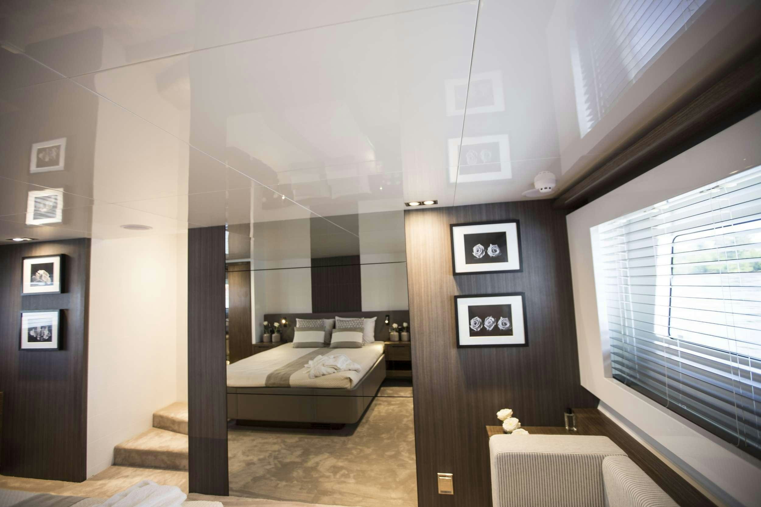 a room with a bed and a window aboard pearl Yacht for Charter