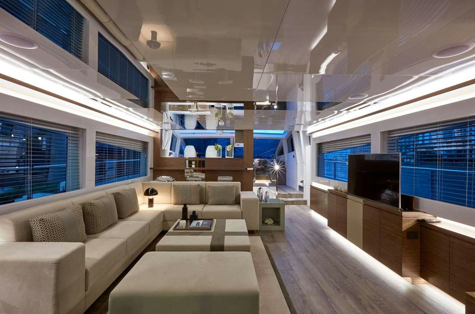 a living room with a large window aboard pearl Yacht for Charter