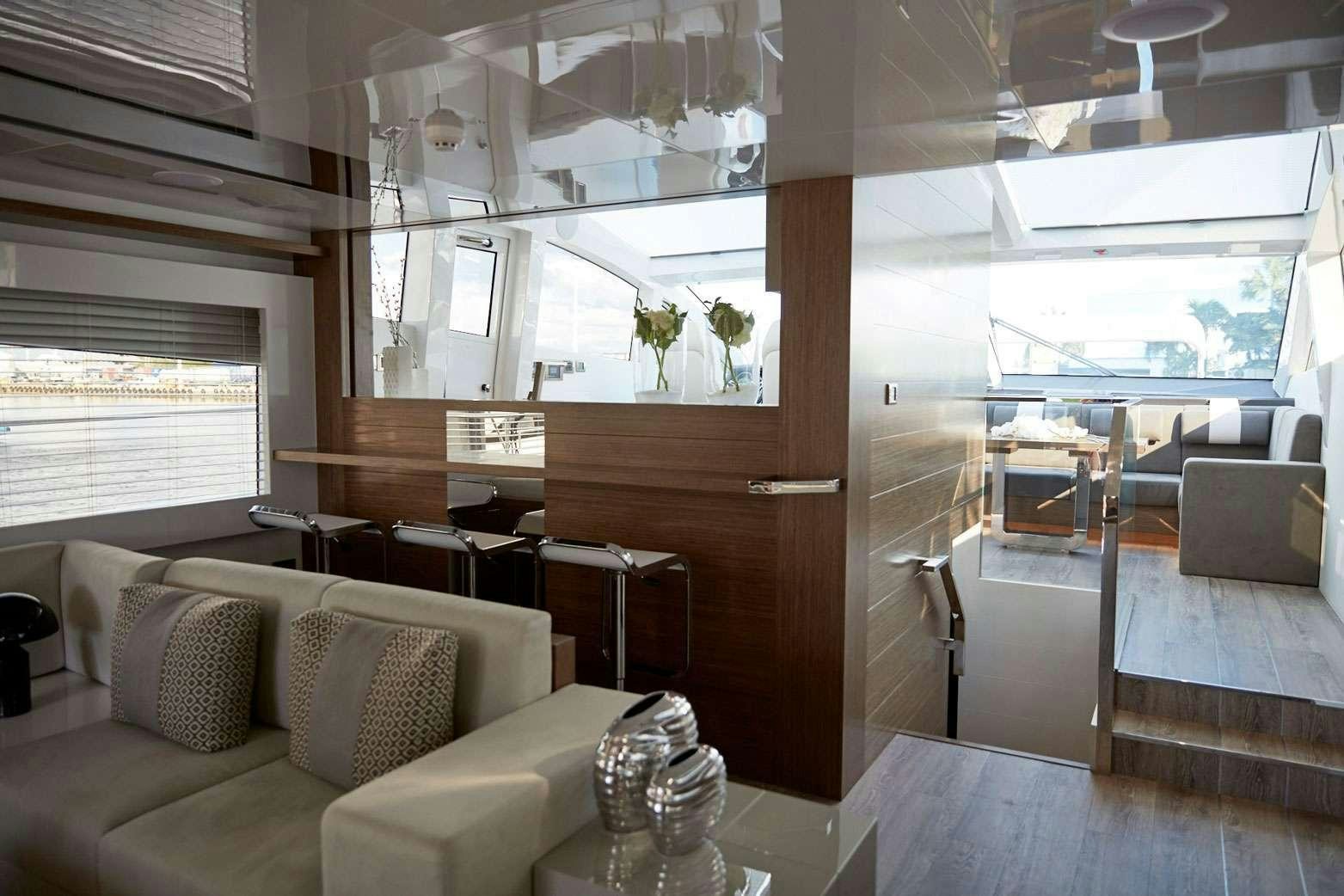 a room with a couch and a table aboard pearl Yacht for Charter