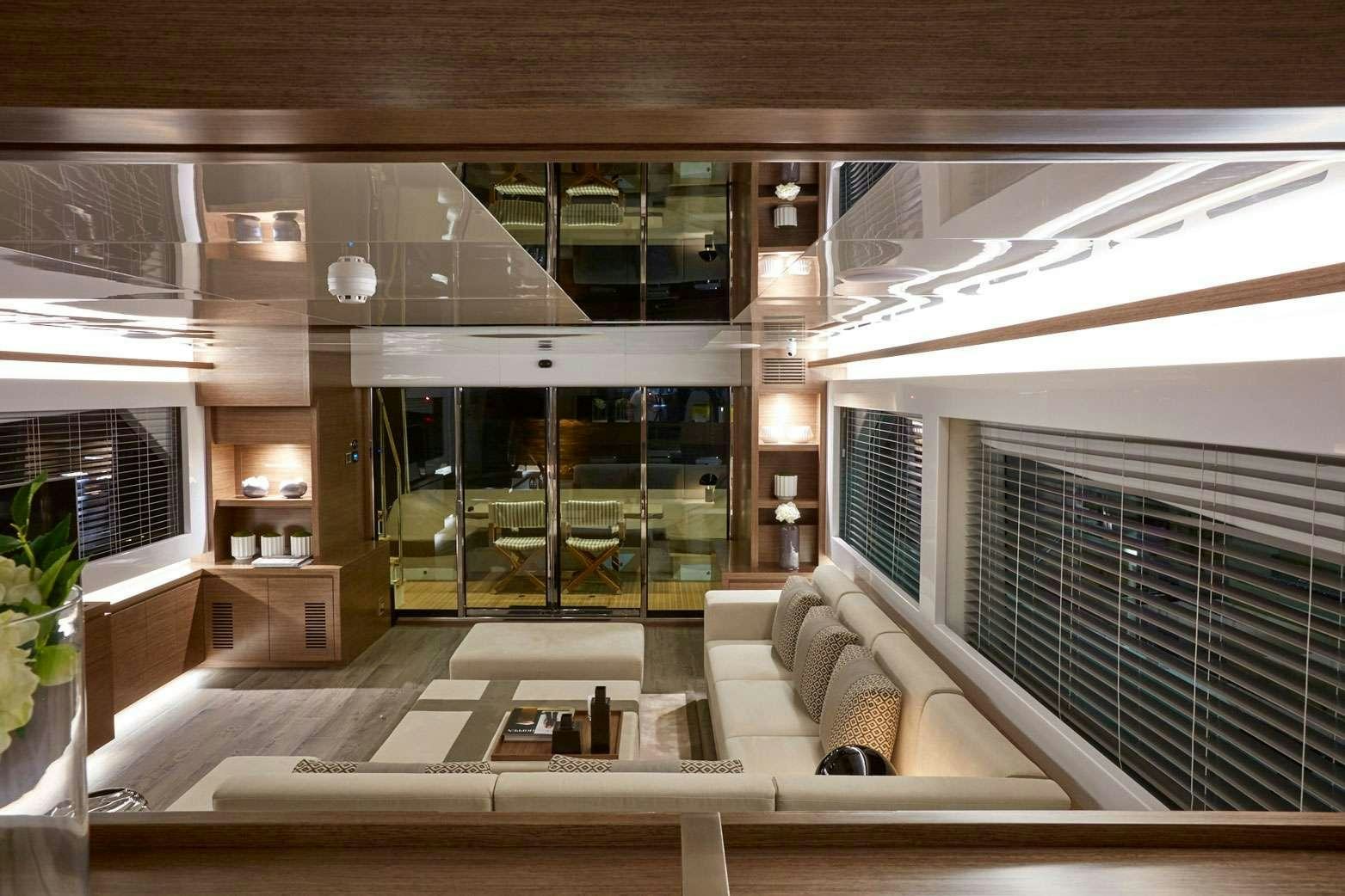 a room with a couch and a table aboard pearl Yacht for Charter