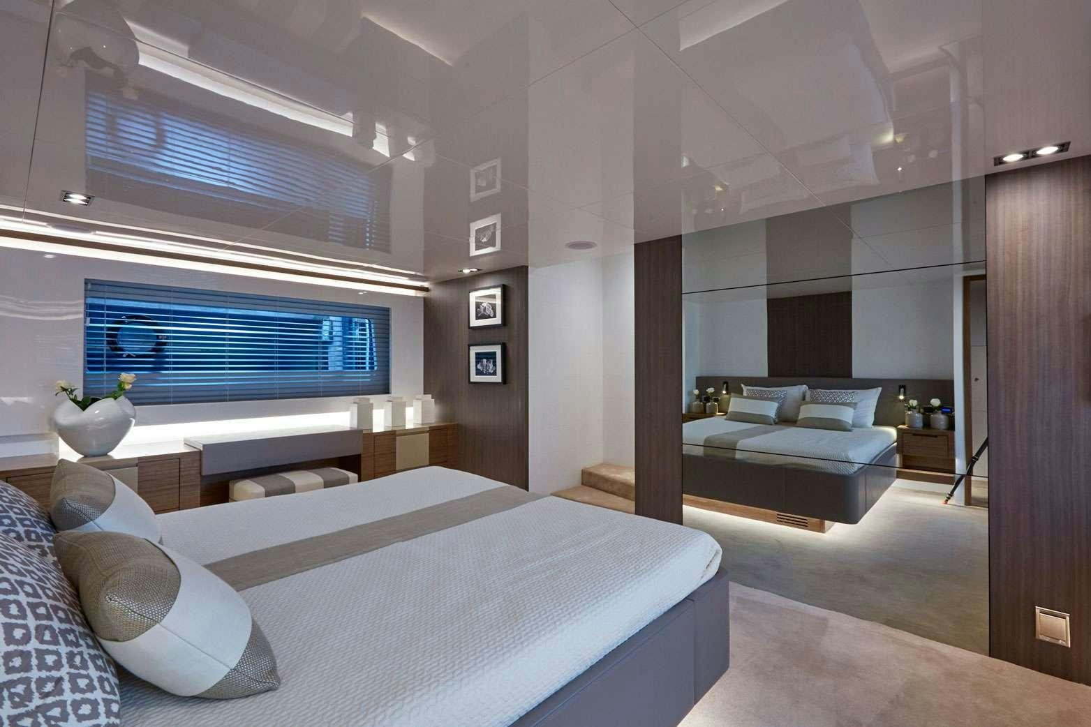 a room with a bed and a couch aboard pearl Yacht for Charter