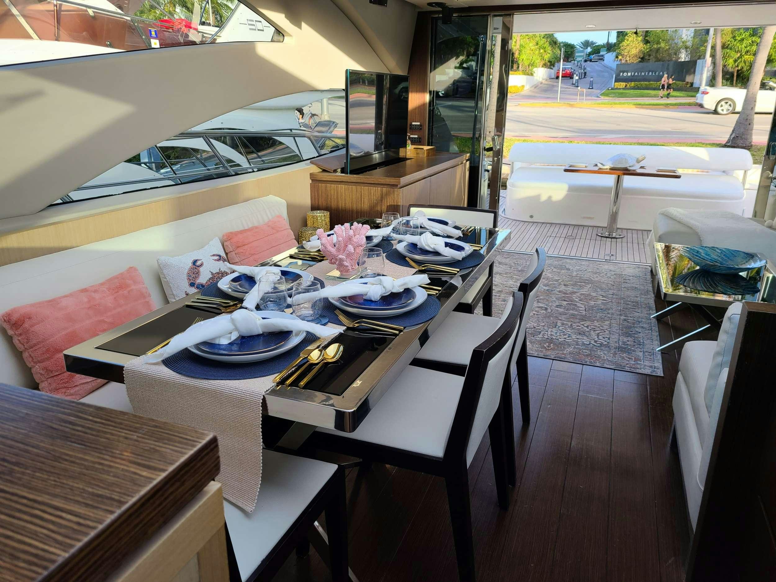 a table with plates and food on it aboard SHOWBOAT Yacht for Charter