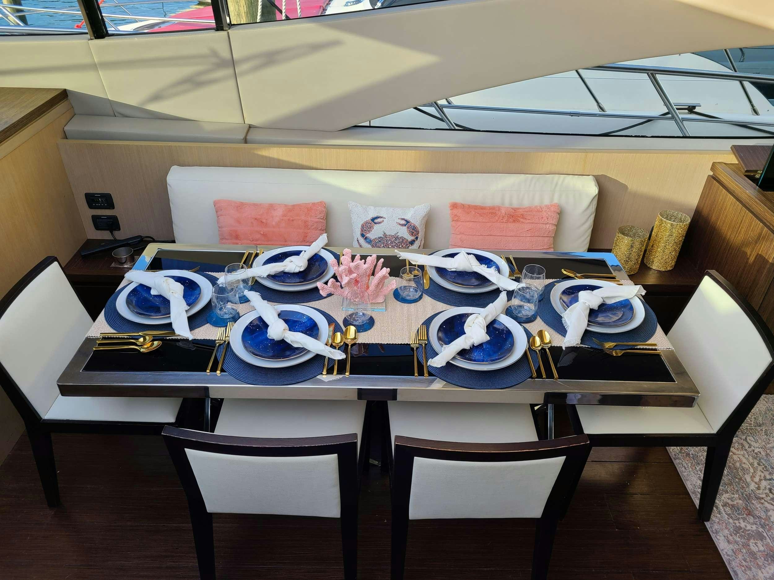 a table with plates and pillows aboard SHOWBOAT Yacht for Charter