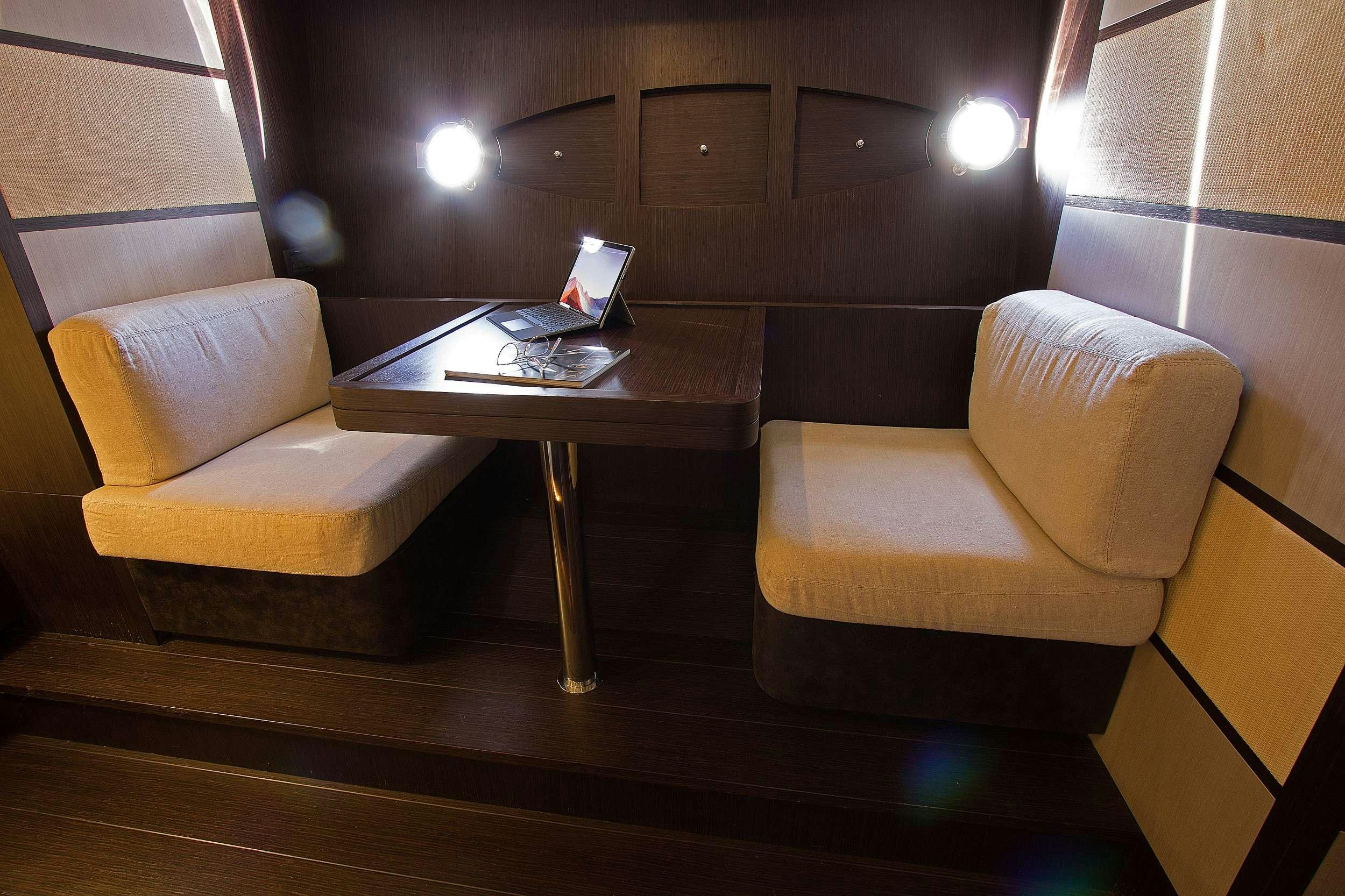 a room with a table and chairs aboard SHOWBOAT Yacht for Charter