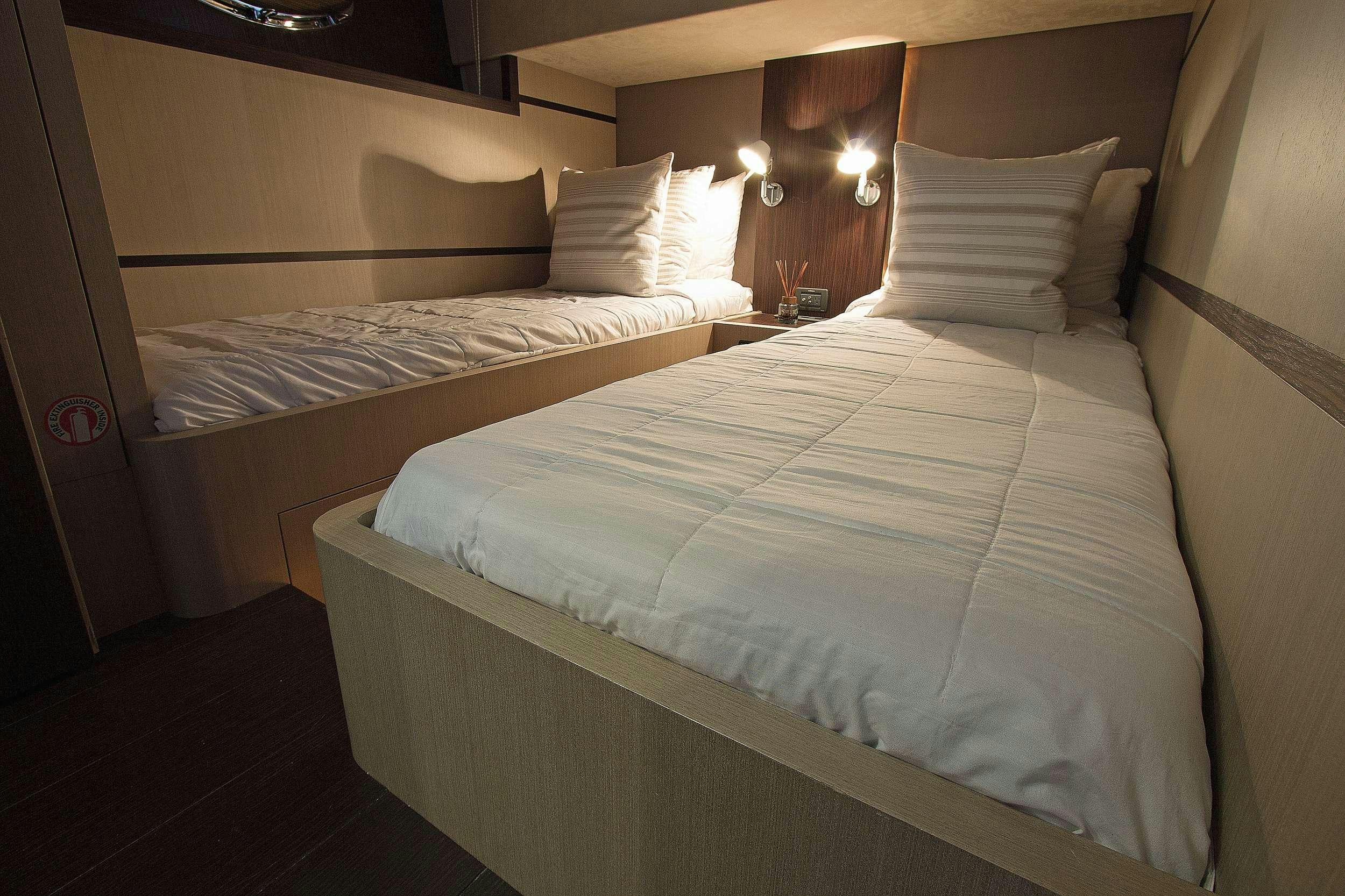 a couple of beds in a hotel room aboard SHOWBOAT Yacht for Charter
