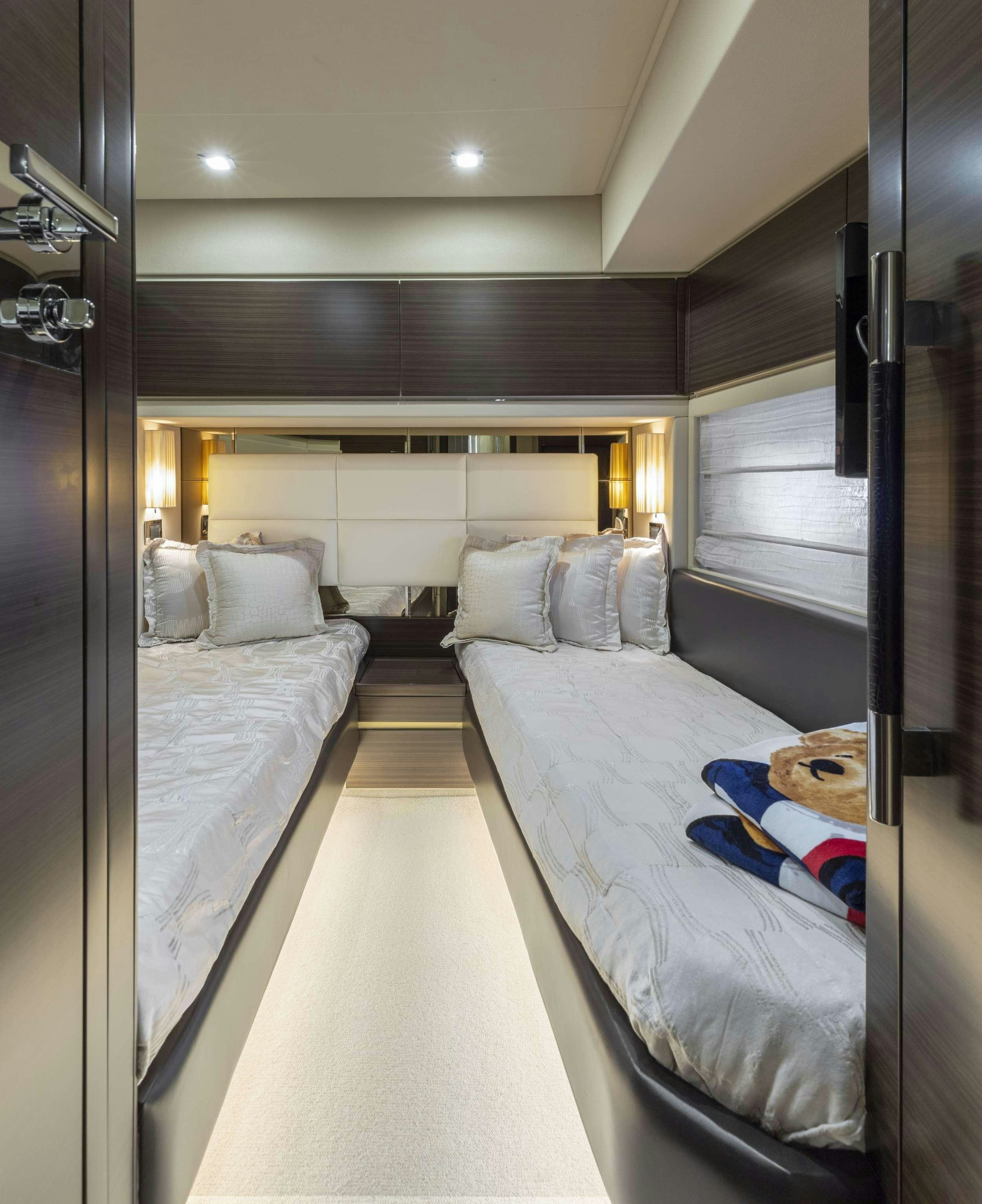 a bedroom with two beds aboard DESSERT FIRST Yacht for Charter