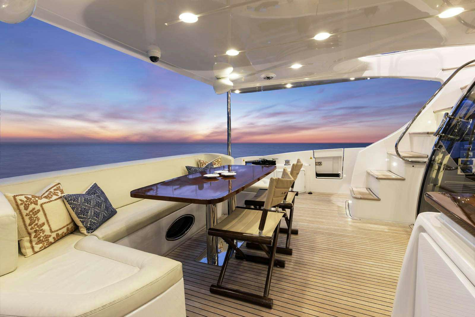 a large cruise ship with a table and chairs aboard DESSERT FIRST Yacht for Charter