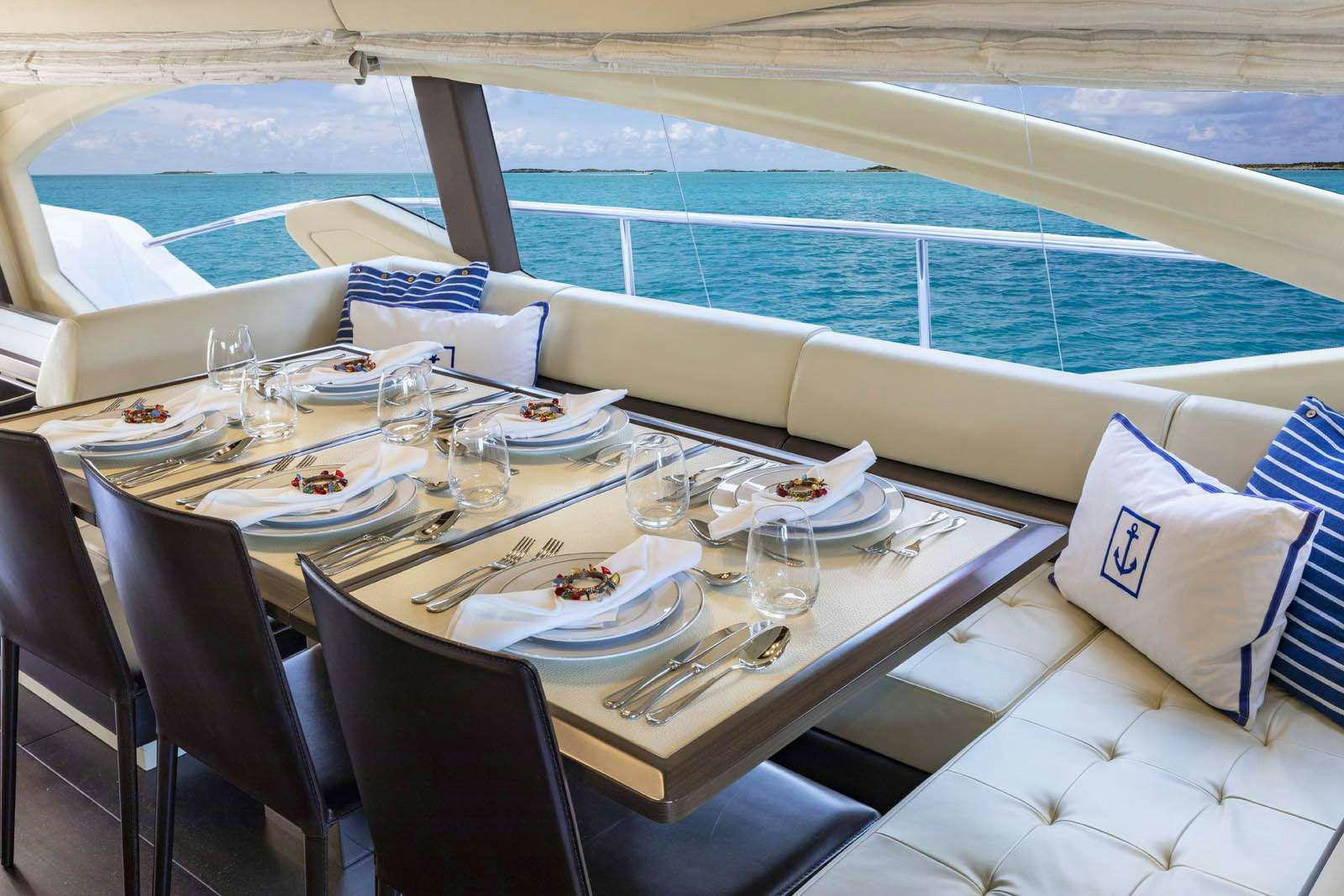 a table with place settings aboard DESSERT FIRST Yacht for Charter
