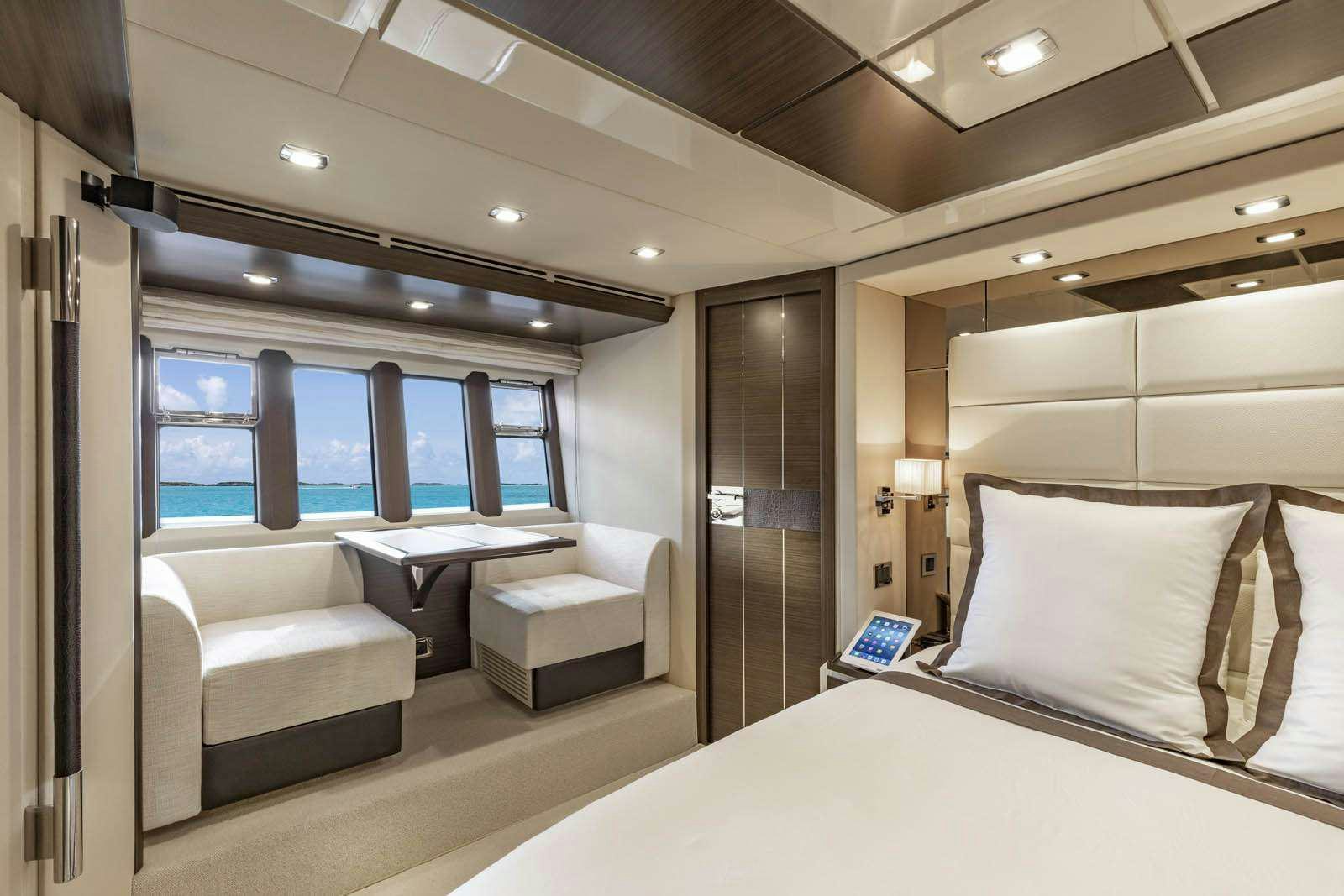a room with a bed and a desk aboard DESSERT FIRST Yacht for Charter