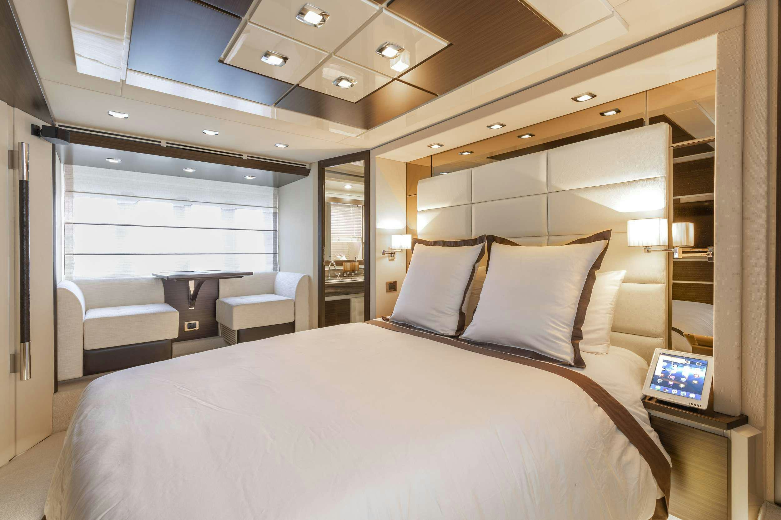 a bed with a white sheet and a laptop on it aboard DESSERT FIRST Yacht for Charter