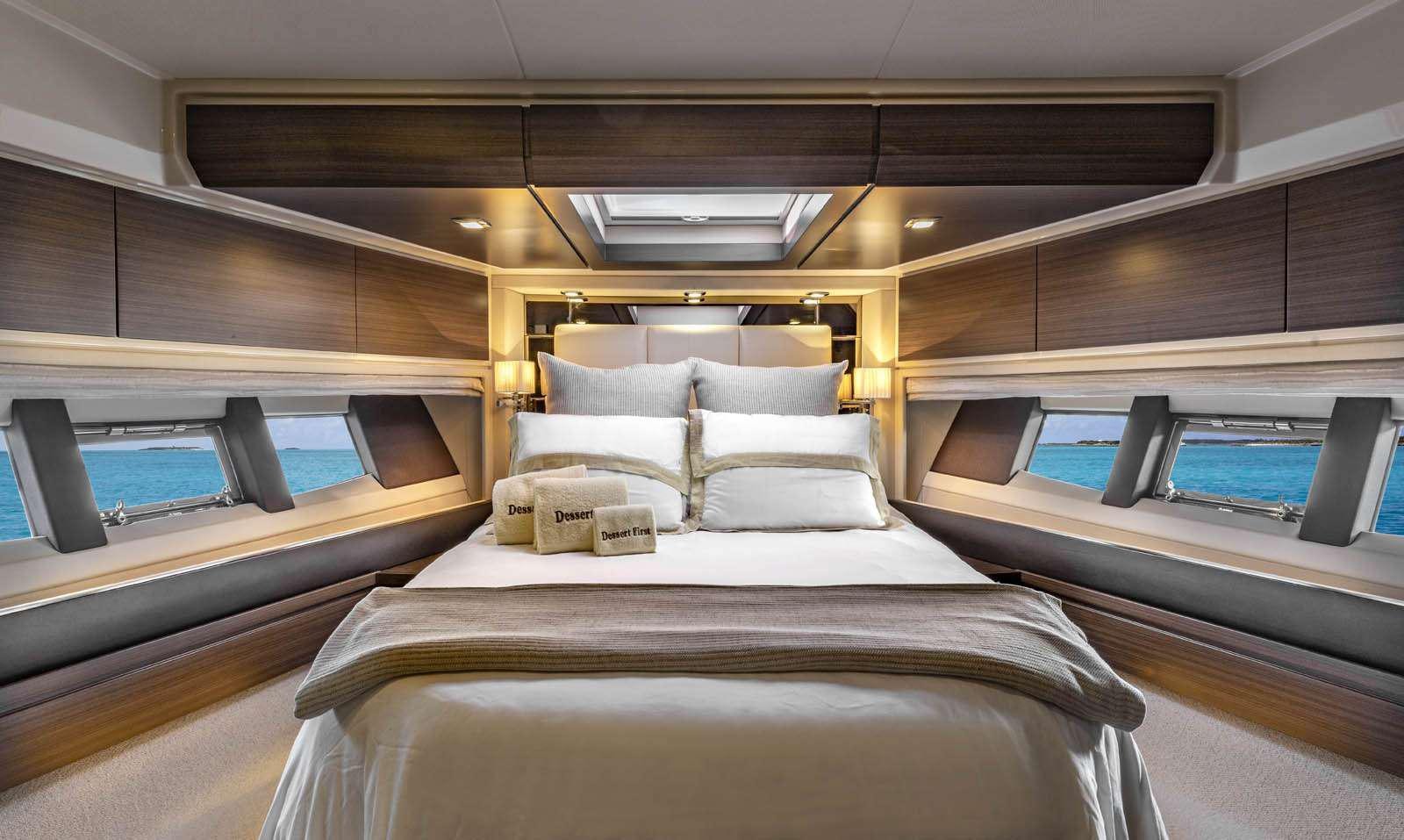 a room with a bed and a desk aboard DESSERT FIRST Yacht for Charter