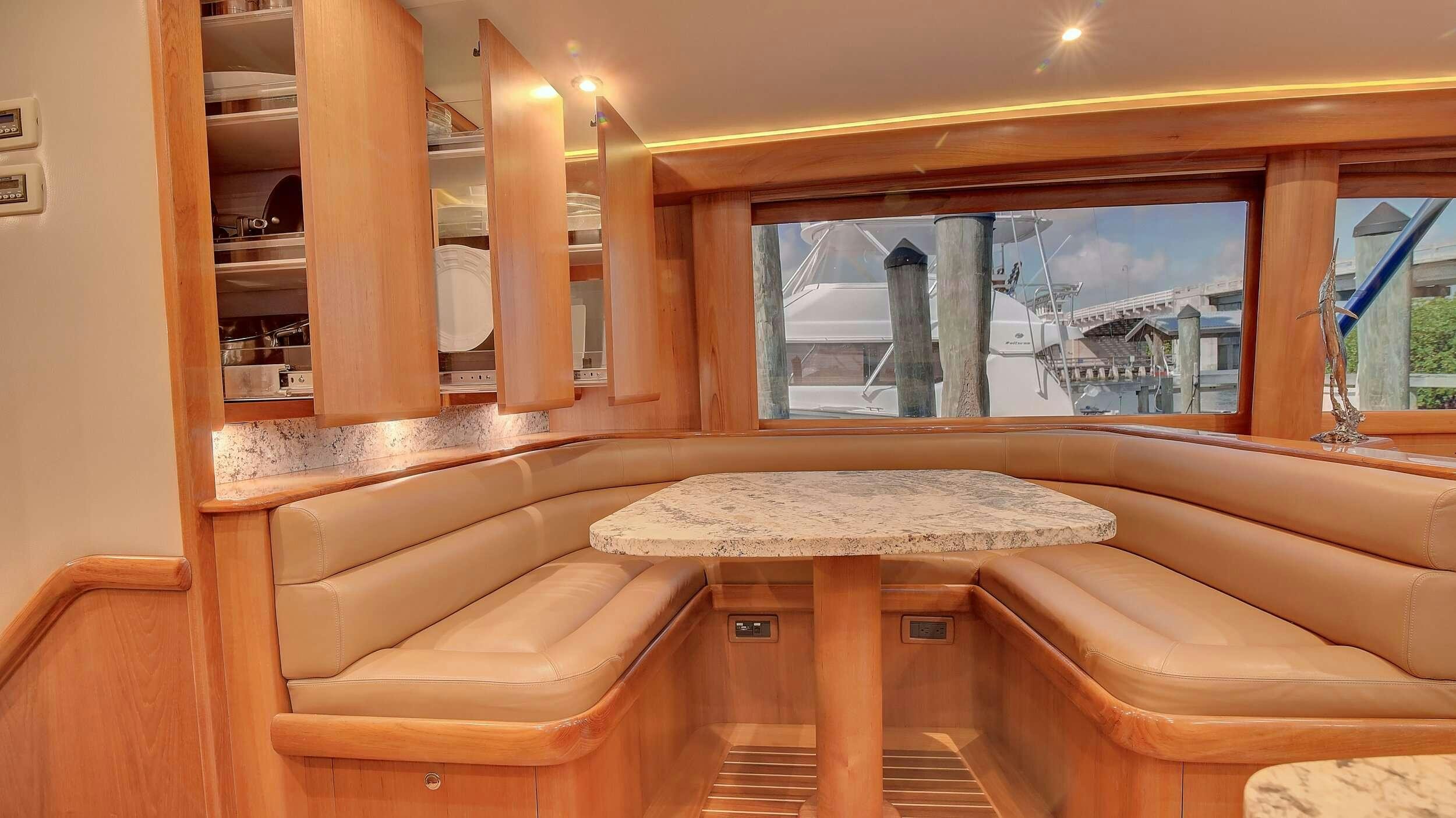 a room with a table and chairs aboard SINGULARIS Yacht for Charter