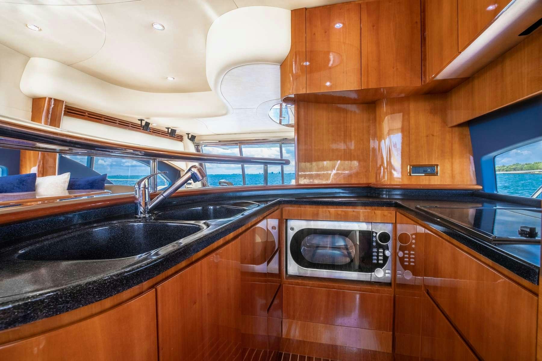 a kitchen with wooden cabinets aboard ALANA ROSE Yacht for Charter