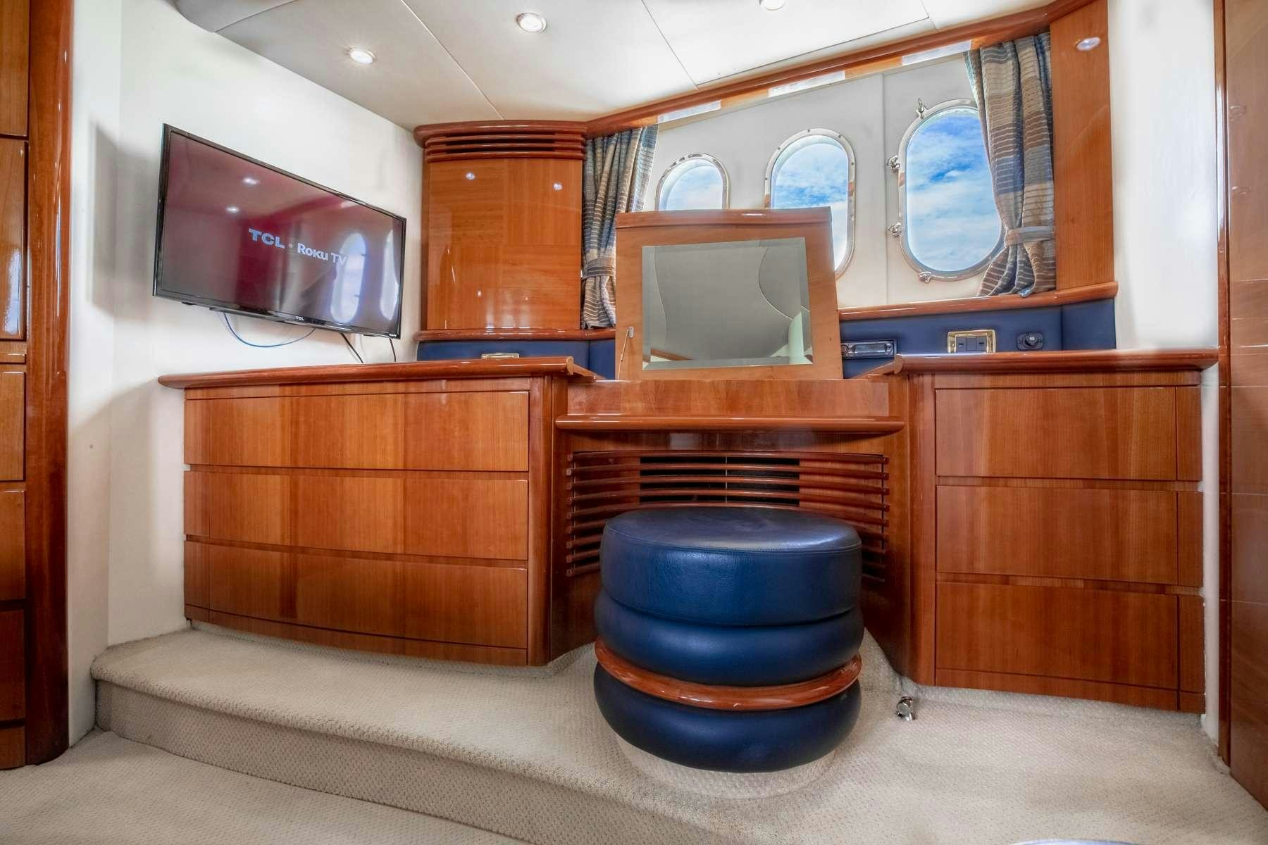 a room with a couch and a television aboard ALANA ROSE Yacht for Charter