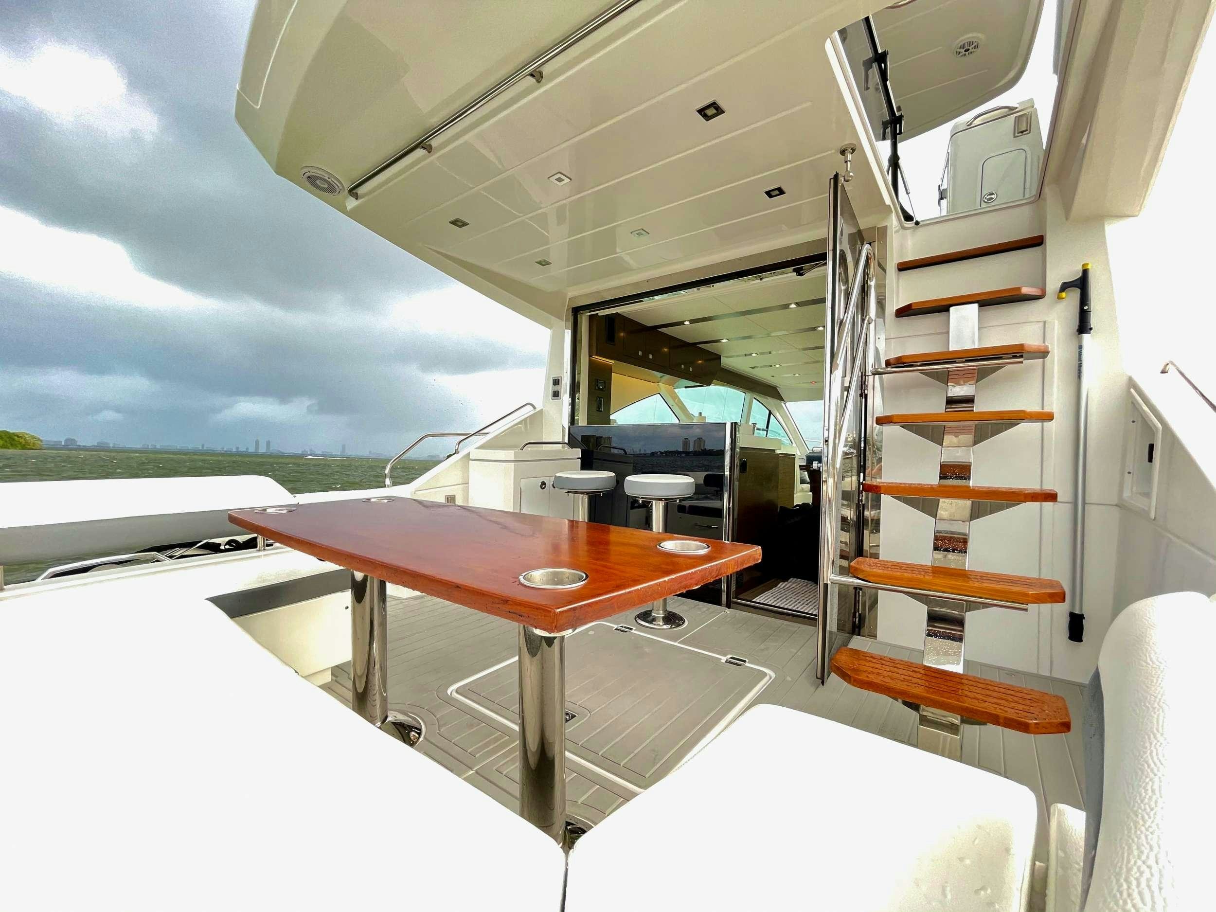 a table with a ladder aboard RIO Yacht for Charter