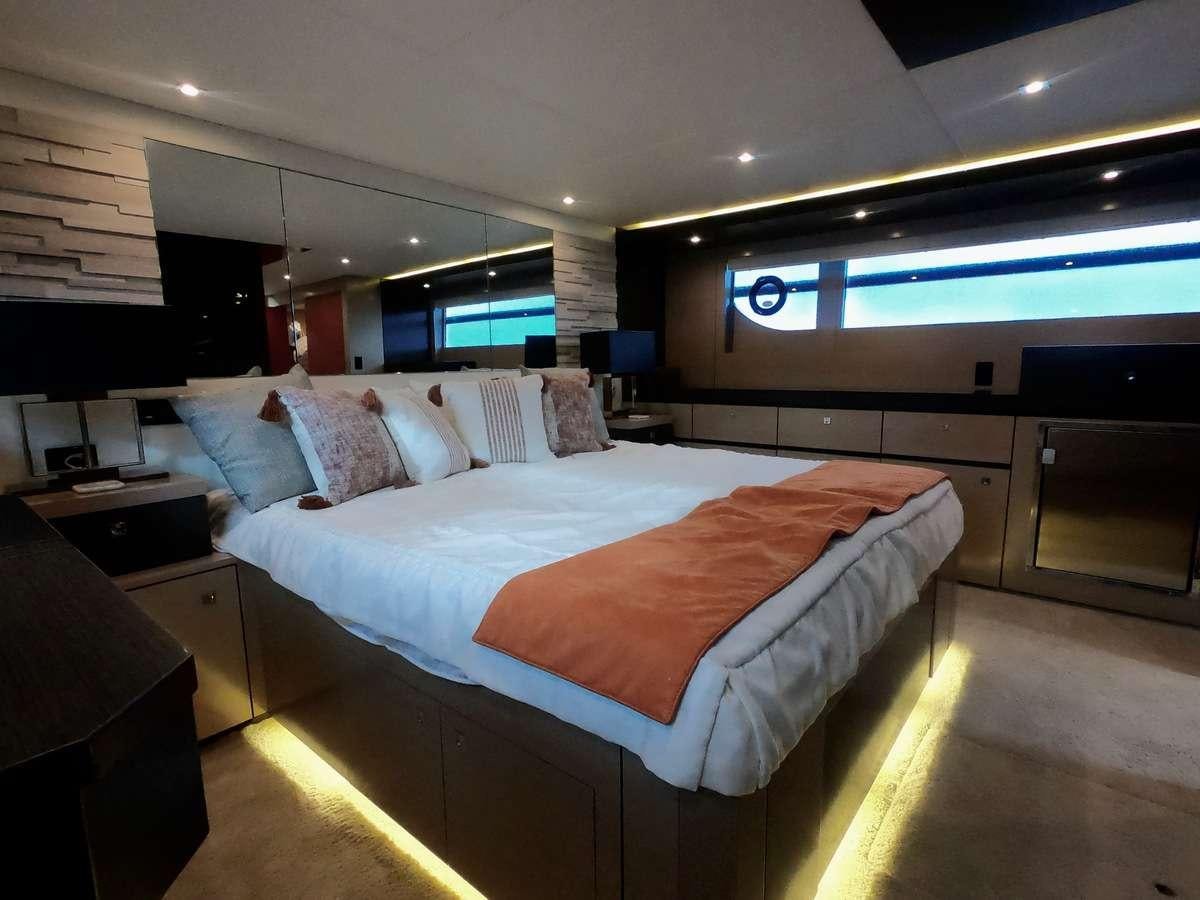 a bedroom with a bed and a desk aboard RIO Yacht for Charter