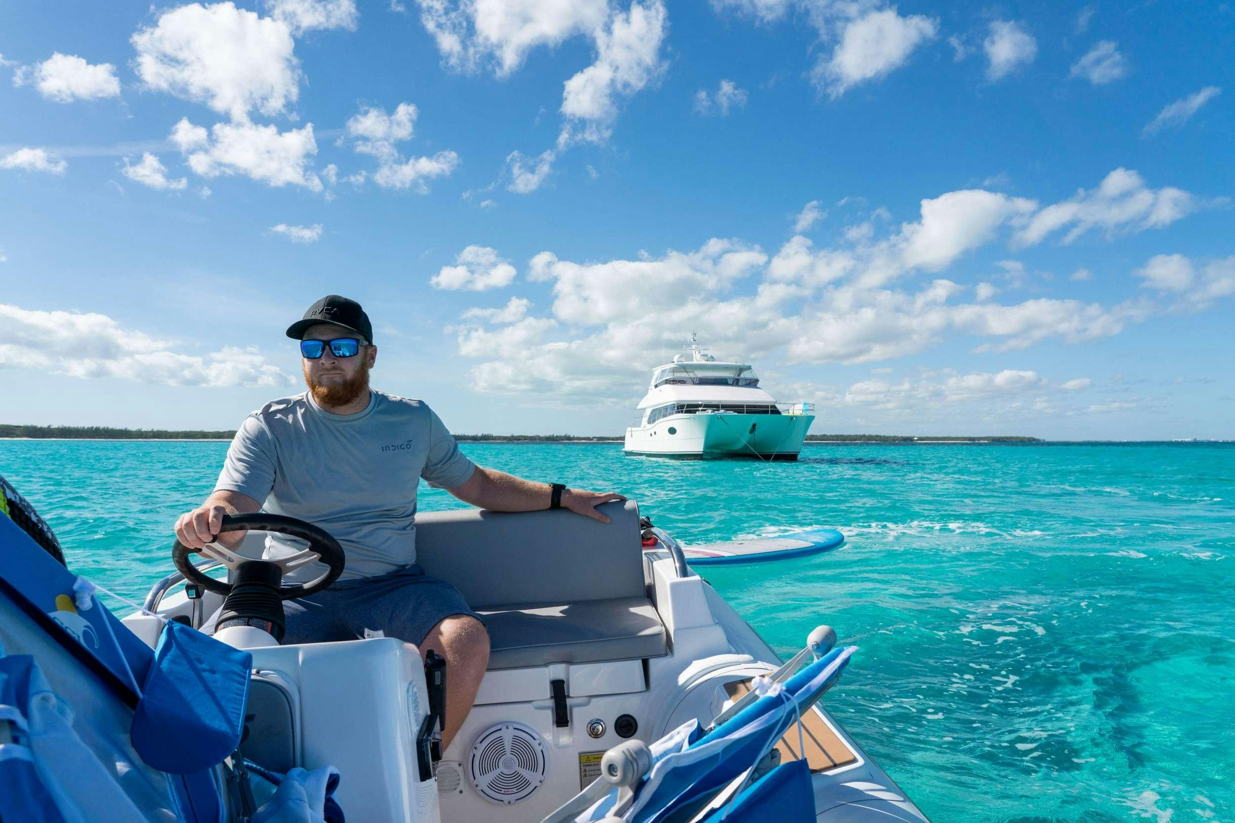a man on a boat aboard INDIGO Yacht for Charter