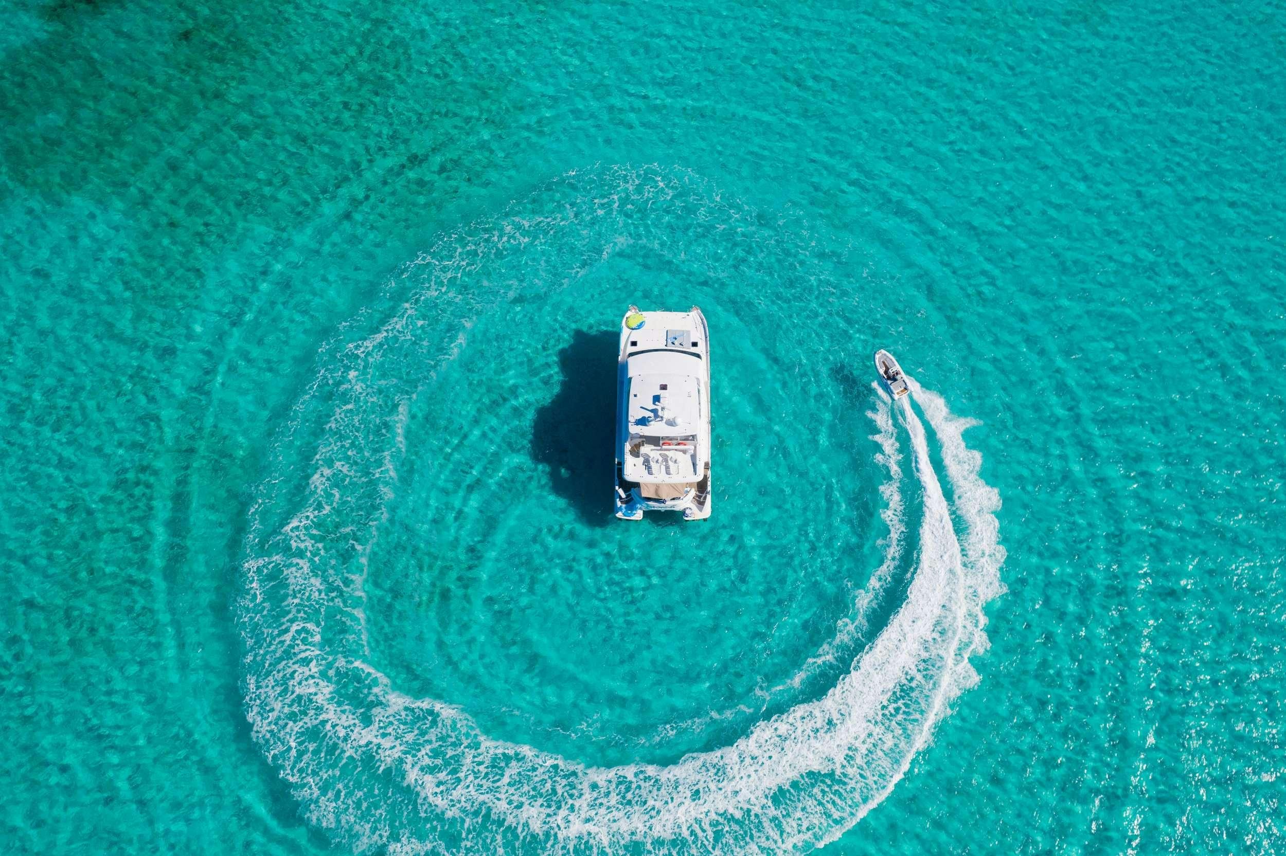 a small white car on a sandy beach aboard INDIGO Yacht for Charter