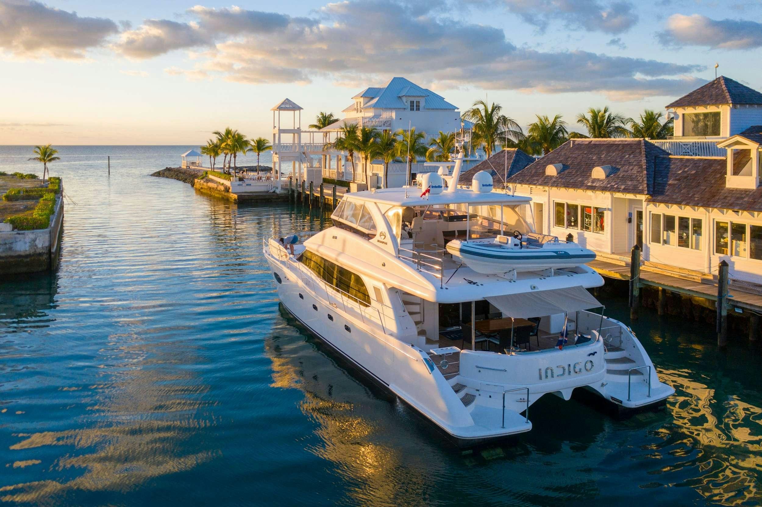 a group of boats docked at a pier aboard INDIGO Yacht for Charter