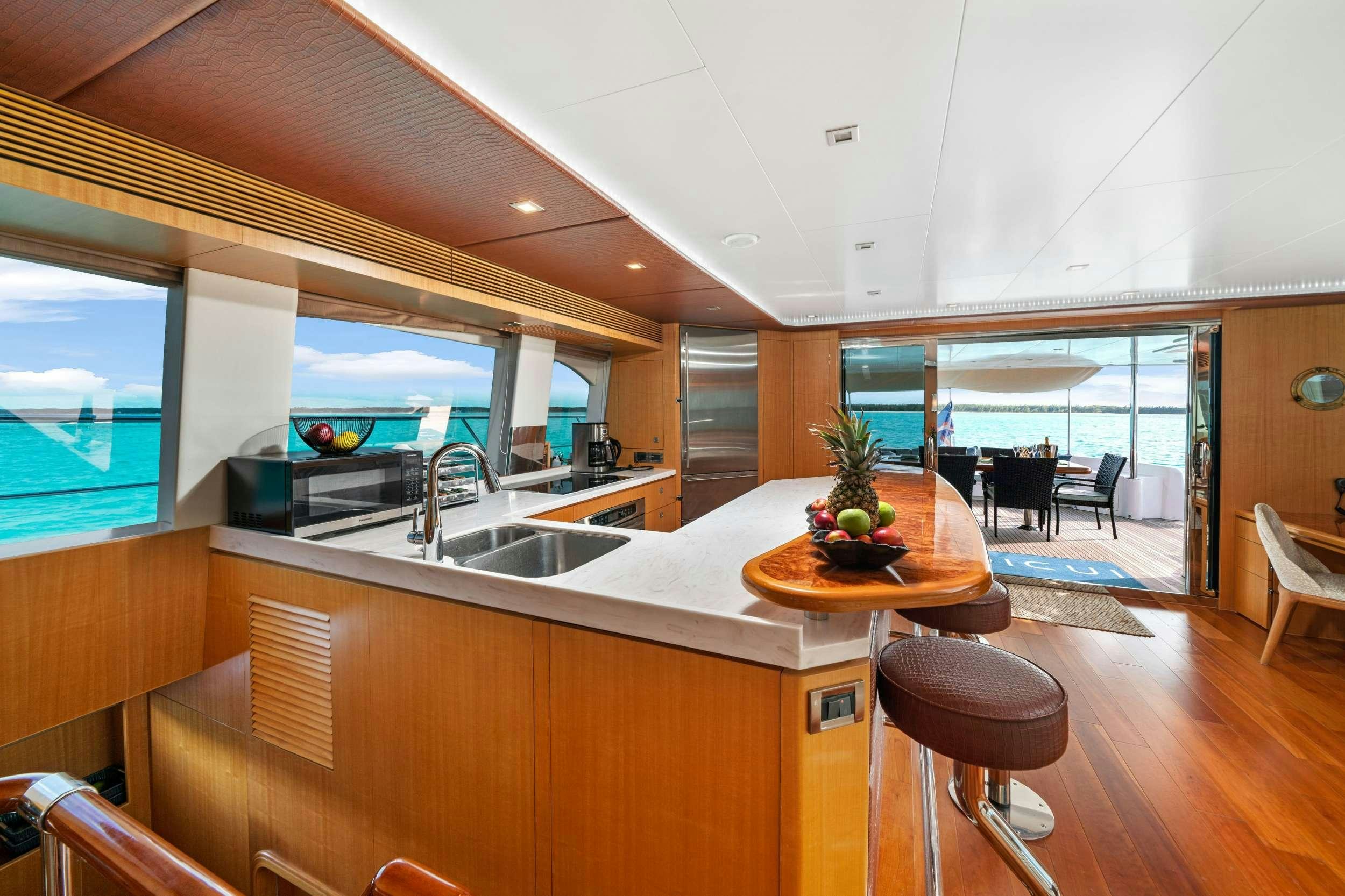 a kitchen with a large window aboard INDIGO Yacht for Charter