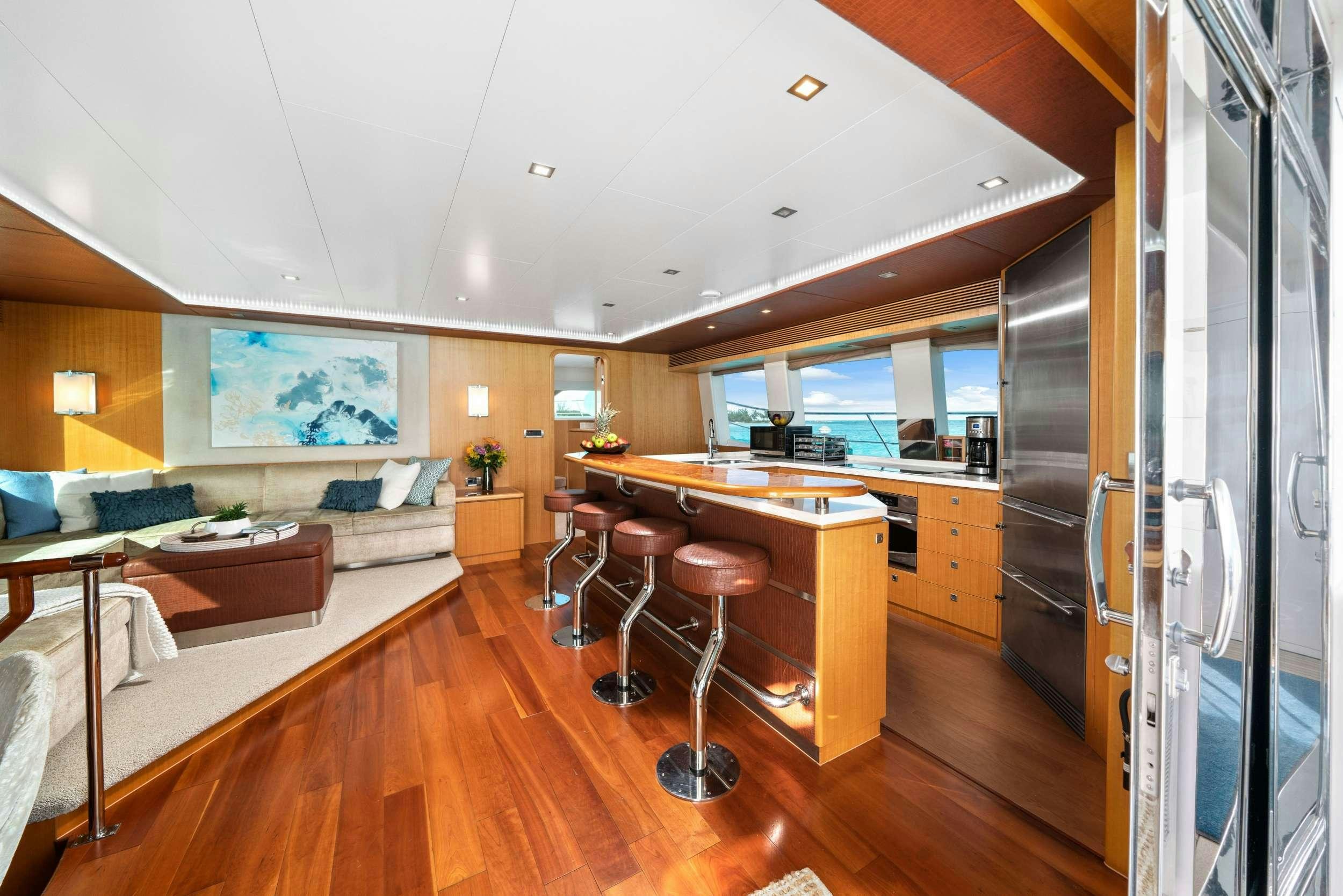 a room with a table chairs and a bed aboard INDIGO Yacht for Charter