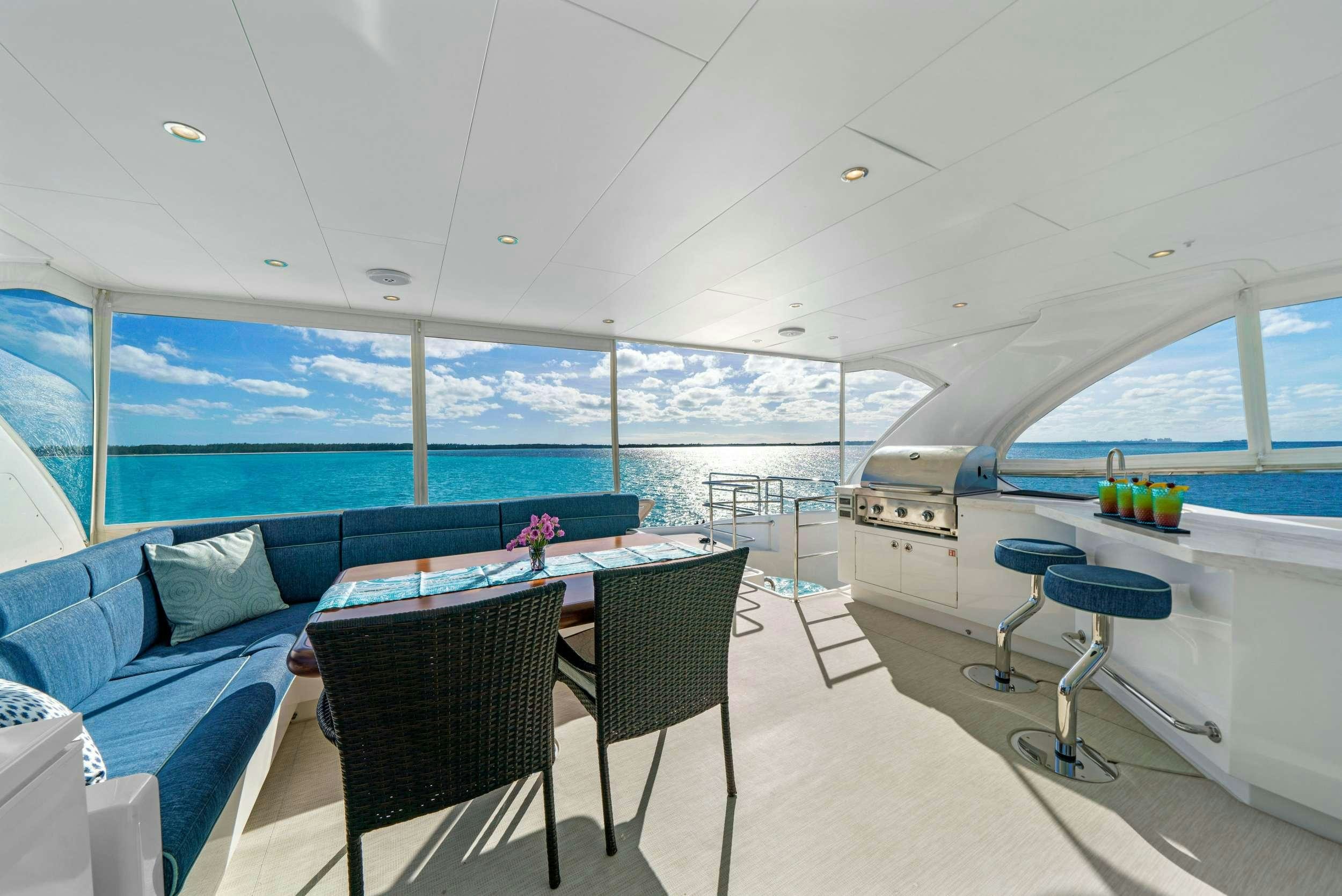 a room with a couch and chairs aboard INDIGO Yacht for Charter