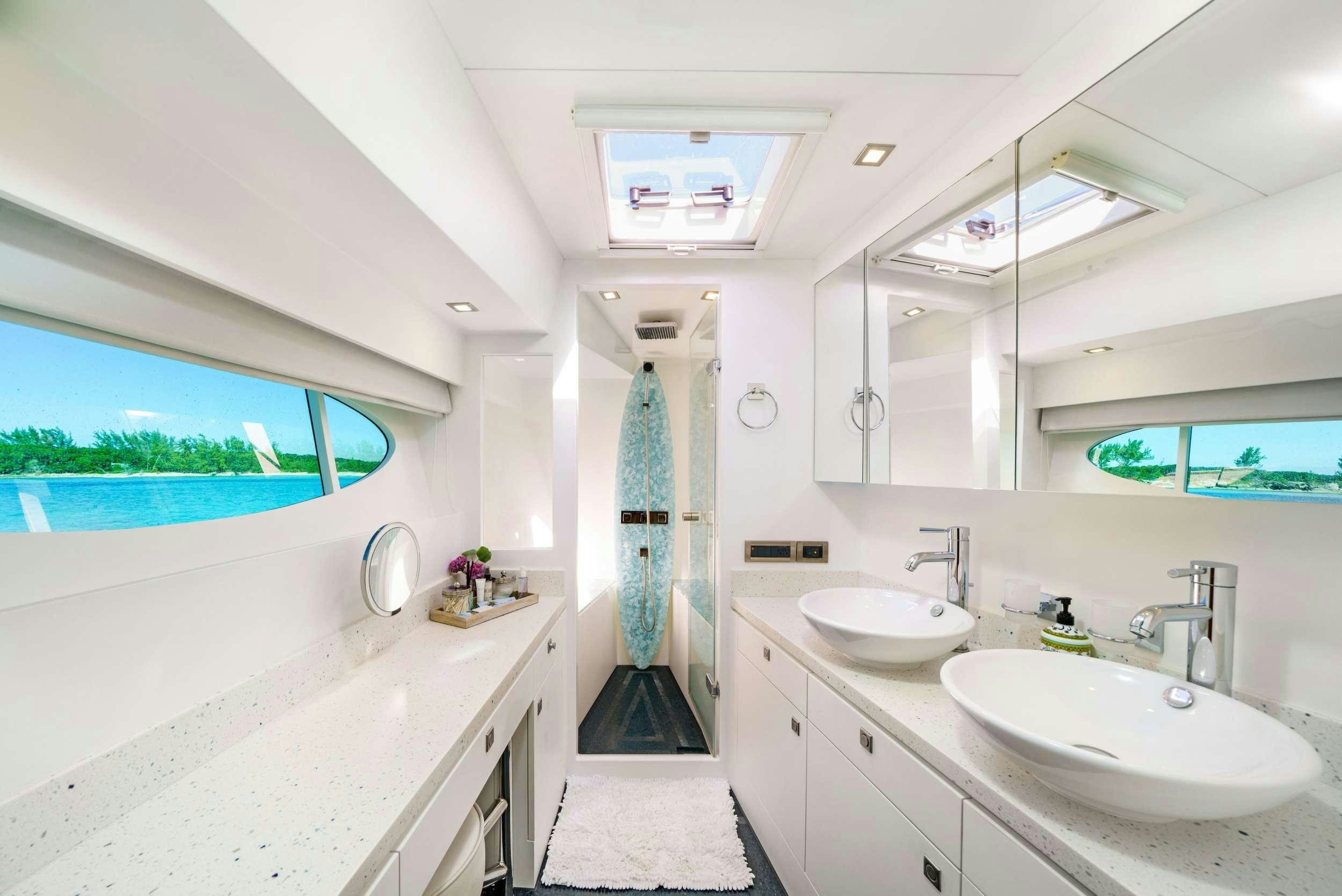 a bathroom with a sink and a large window aboard INDIGO Yacht for Charter
