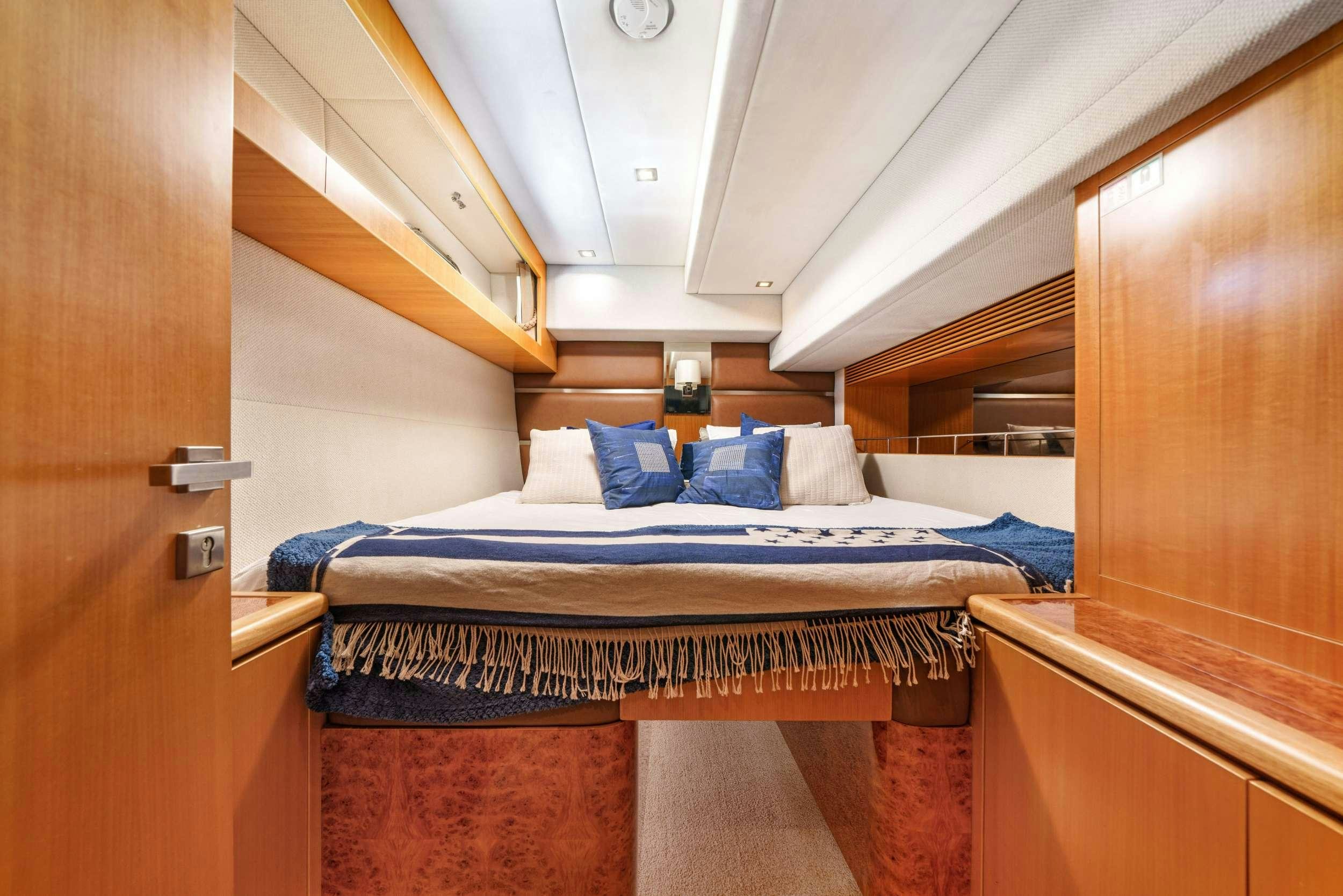 a bed with a blue sheet aboard INDIGO Yacht for Charter