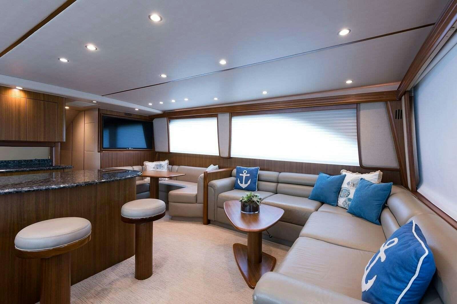 a living room with a couch and a table aboard JAYWALKER Yacht for Charter