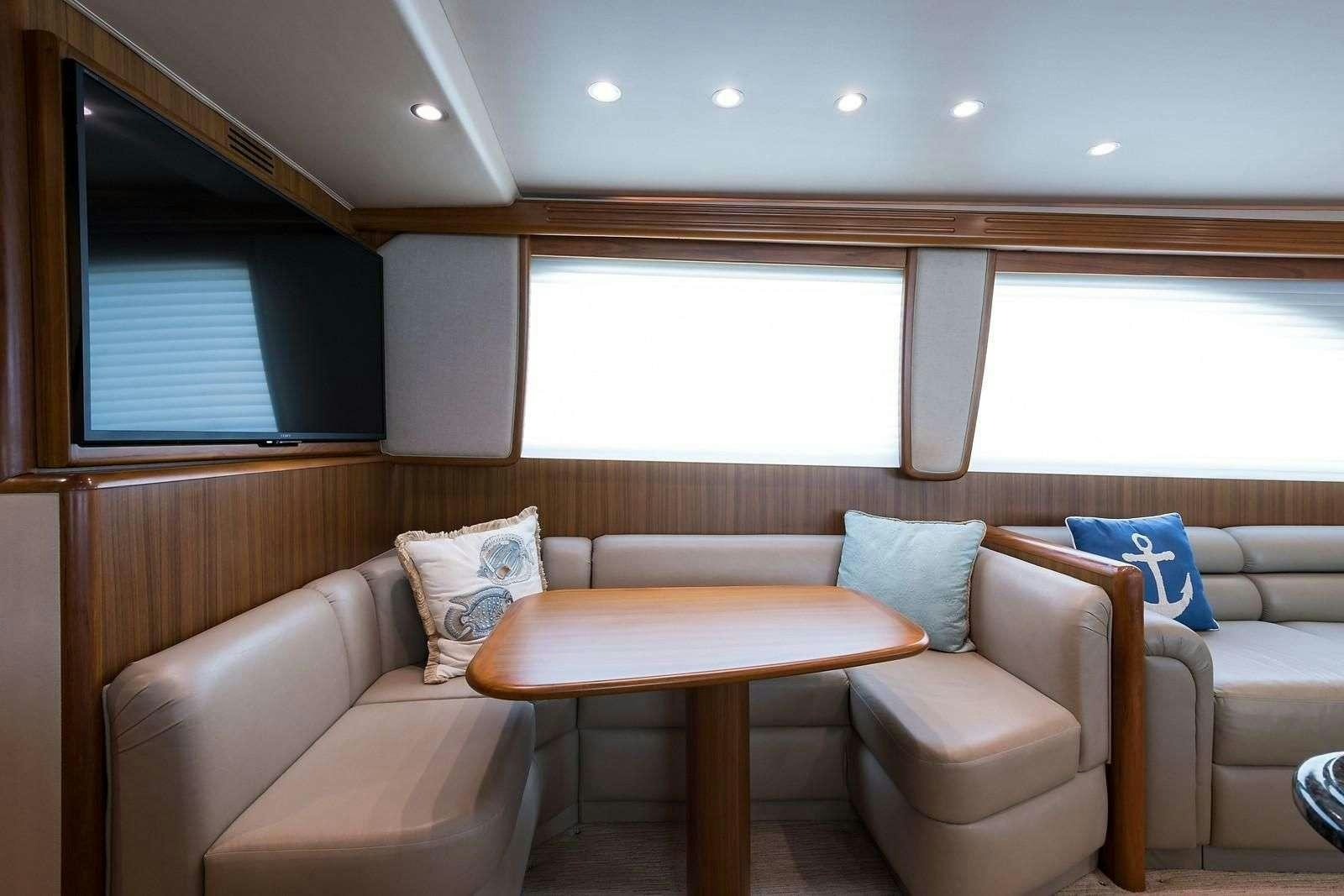 a living room with a couch and a table aboard JAYWALKER Yacht for Charter