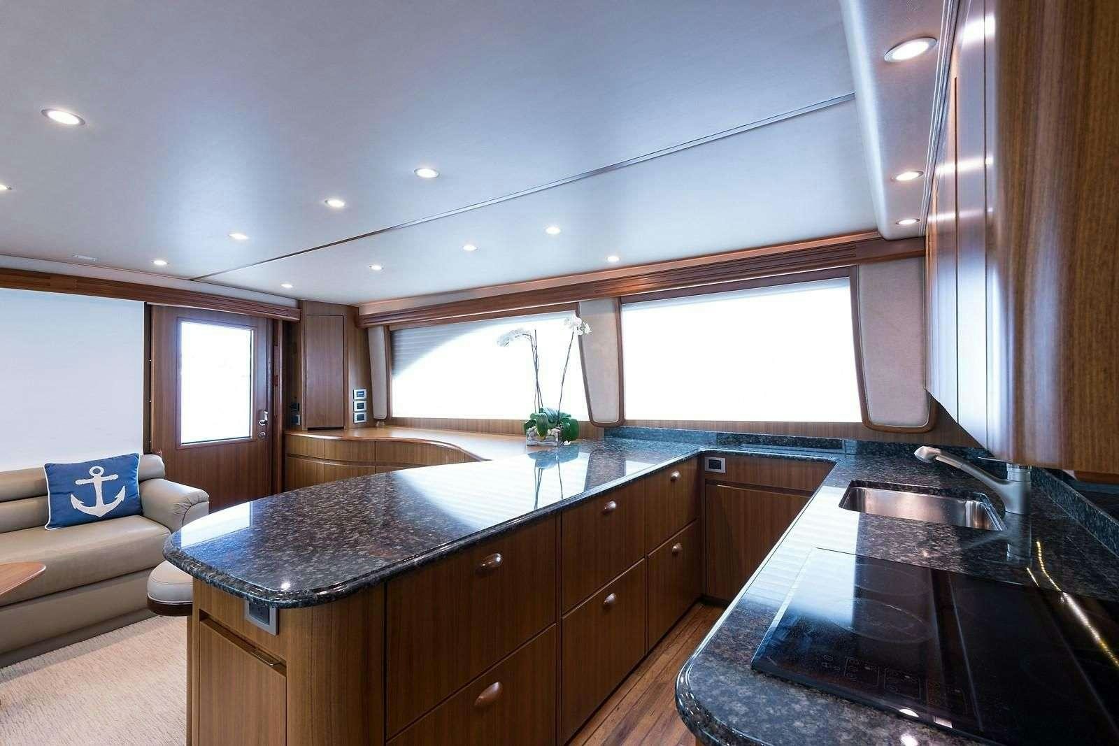 a kitchen with a black countertop aboard JAYWALKER Yacht for Charter
